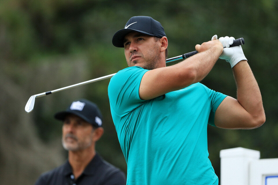  HILTON HEAD ISLAND, SOUTH CAROLINA - JUNE 17: Brooks Koepka of the United States plays a shot as coach Claude Harmon III looks on during a practice round prior to the RBC Heritage on June 17, 2020 at Harbour Town Golf Links in Hilton Head Island, So