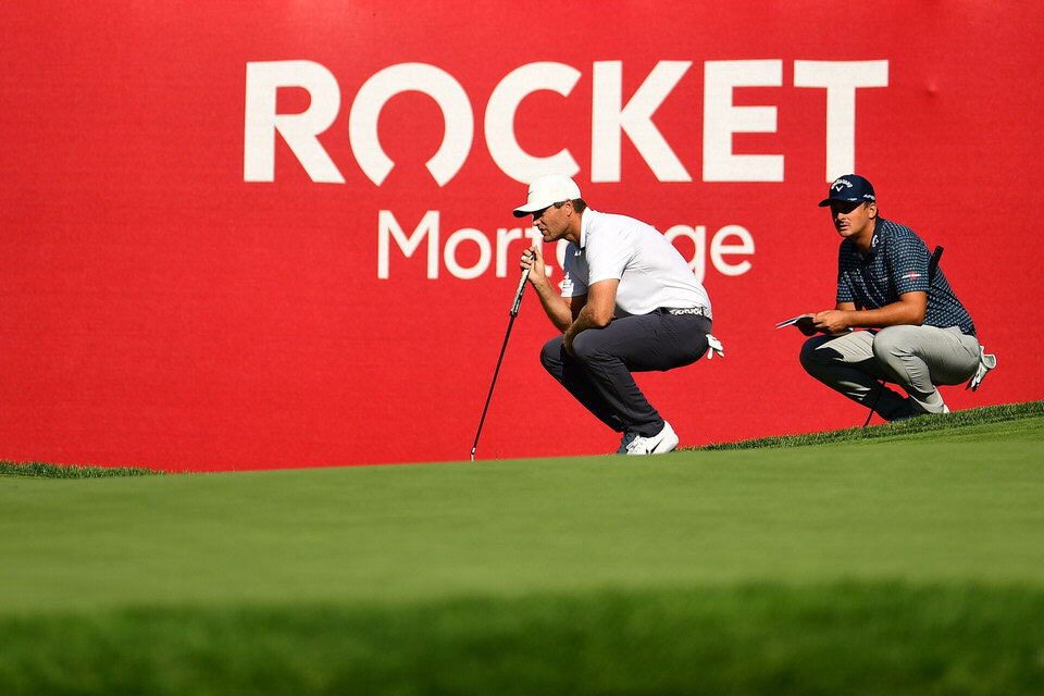  DETROIT, MICHIGAN - JULY 02: Lucas Bjerregaard of Denmark and Christiaan Bezuidenhout of South Africa lines up a putt on the 14th green during the first round of the Rocket Mortgage Classic on July 02, 2020 at the Detroit Golf Club in Detroit, Michi