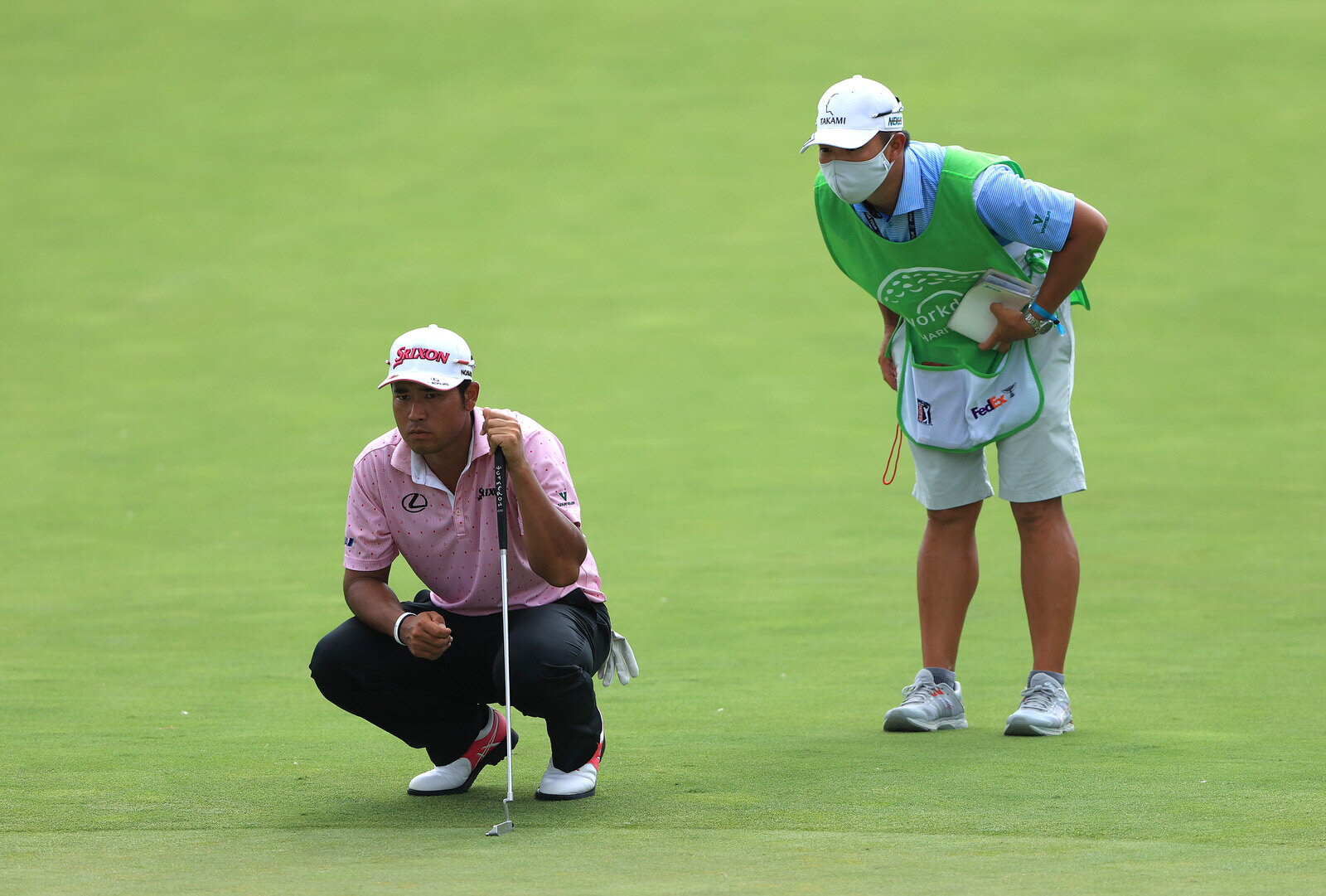  DUBLIN, OHIO - JULY 10: Hideki Matsuyama of Japan talks with his caddie Shota Hayafuji on the 16th green during the second round of the Workday Charity Open on July 10, 2020 at Muirfield Village Golf Club in Dublin, Ohio. (Photo by Sam Greenwood/Get