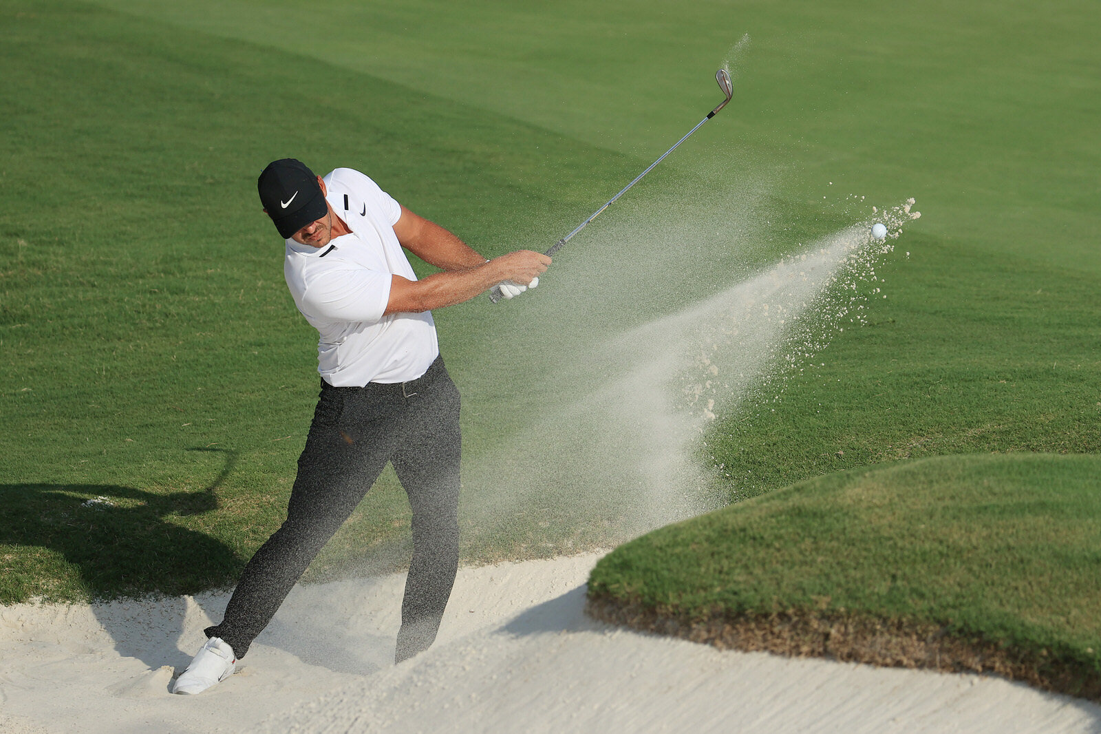  MEMPHIS, TENNESSEE - AUGUST 02:  Brooks Koepka of the United States plays a shot from a bunker on the 18th hole during the final round of the World Golf Championship-FedEx St Jude Invitational at TPC Southwind on August 02, 2020 in Memphis, Tennesse