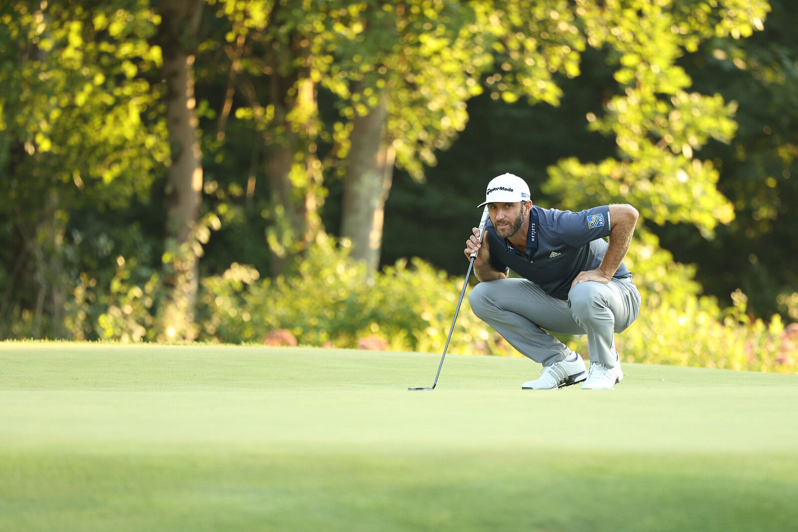  NORTON, MASSACHUSETTS - AUGUST 22: Dustin Johnson of the United States lines up a putt on the 18th green during the third round of The Northern Trust at TPC Boston on August 22, 2020 in Norton, Massachusetts. (Photo by Maddie Meyer/Getty Images) 