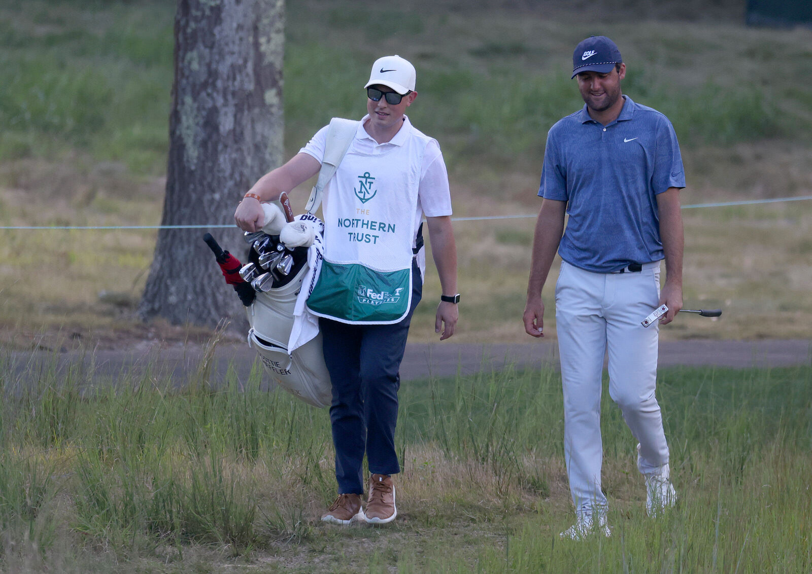 NORTON, MASSACHUSETTS - AUGUST 23: Eric Ledbetter, an assistant pro at TPC Boston, walks to the 16th green as he caddies for Scottie Scheffler of the United States during the final round of The Northern Trust at TPC Boston on August 23, 2020 in Nort
