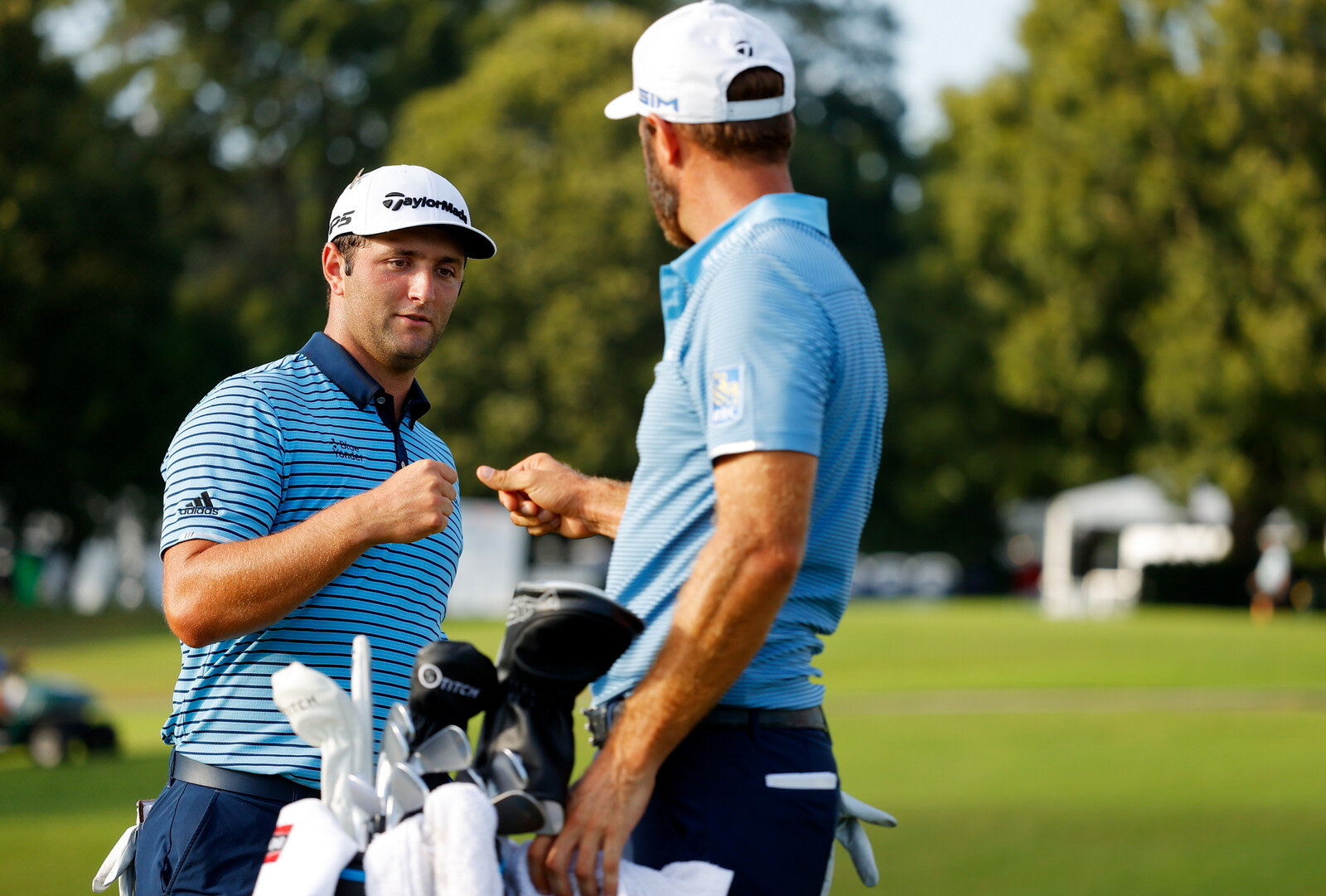  ATLANTA, GEORGIA - SEPTEMBER 04: Jon Rahm of Spain and Dustin Johnson of the United States bump fists on the 18th green during the first round of the TOUR Championship at East Lake Golf Club on September 04, 2020 in Atlanta, Georgia. (Photo by Kevin