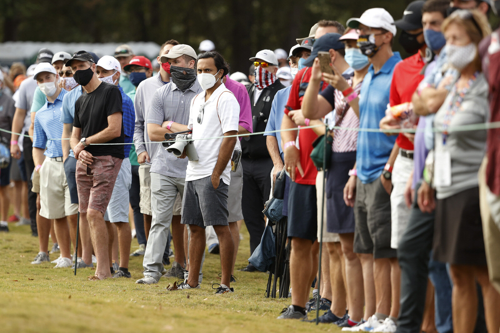  HOUSTON, TEXAS - NOVEMBER 05: Fans, wearing masks, watch action on the ninth green during the first round of the Vivint Houston Open at Memorial Park Golf Course on November 05, 2020 in Houston, Texas. The Vivint Houston Open is the first PGA Tour e