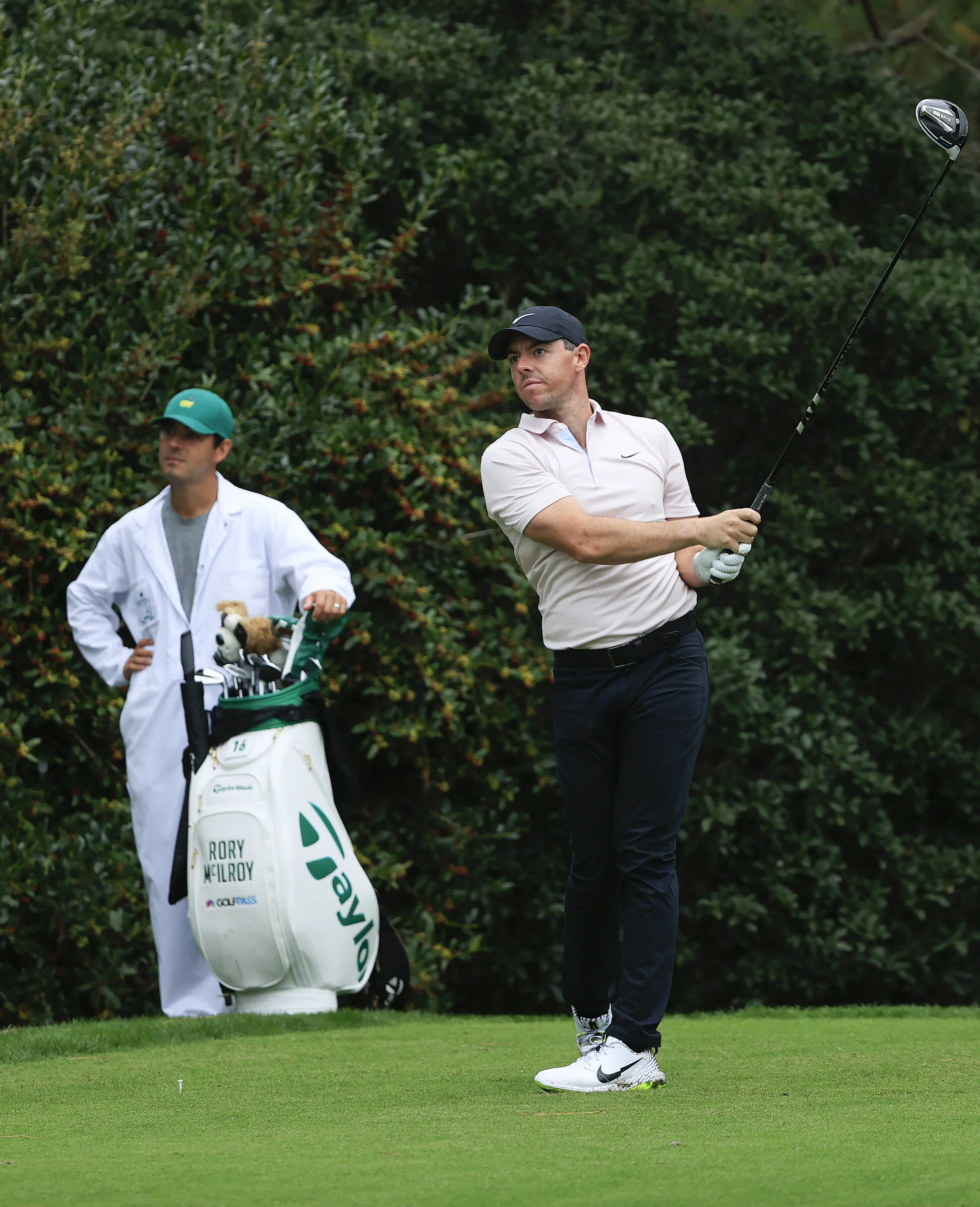 Rory McIlroy plays his stroke from the No. 15 tee as caddie Harry Diamond looks on during Practice Round 3 for the Masters at Augusta National Golf Club, Tuesday, November 10, 2020.