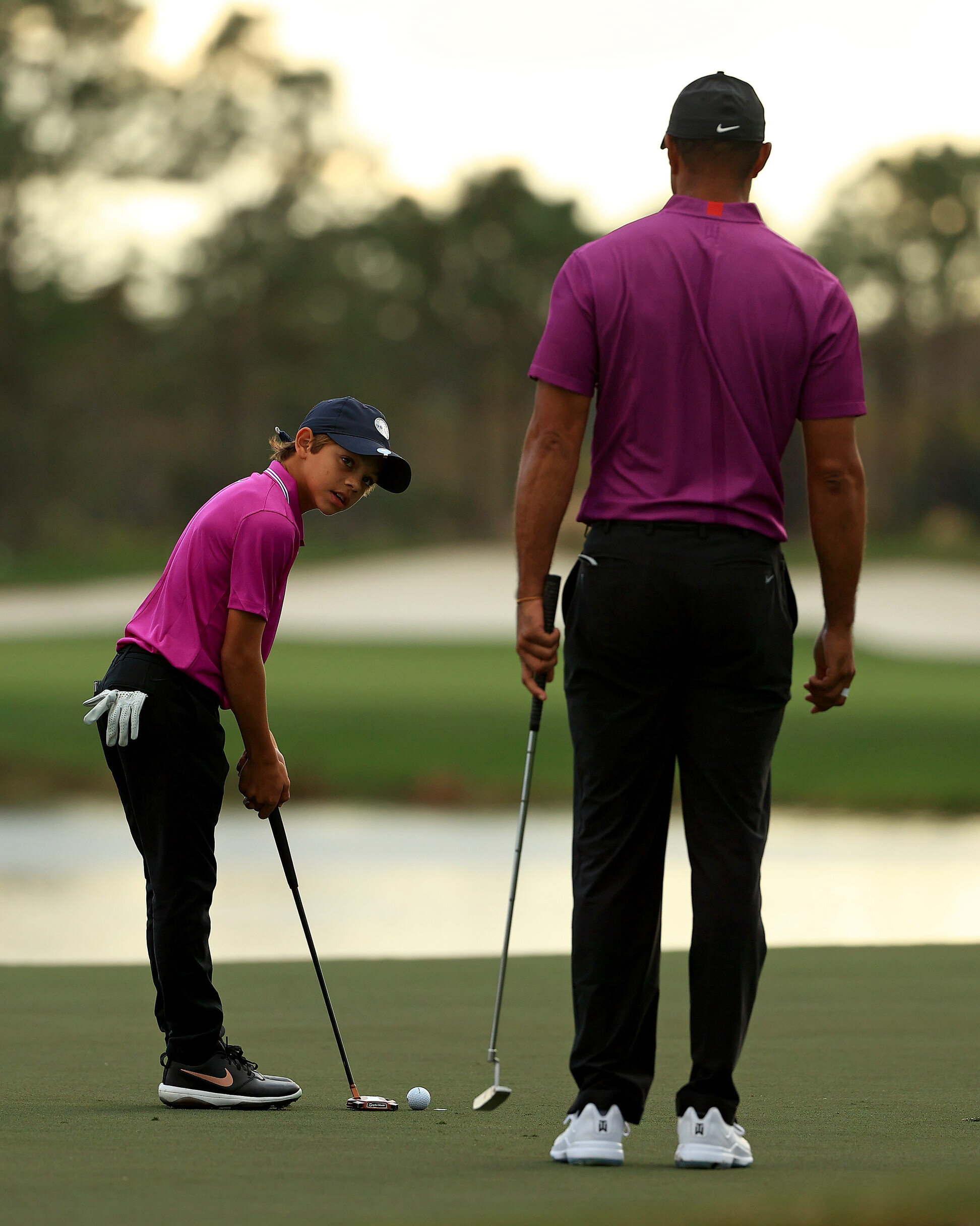  ORLANDO, FLORIDA - DECEMBER 19: Tiger Woods of the United States and son Charlie Woods lines up a putt on the 15th hole during the first round of the PNC Championship at the Ritz Carlton Golf Club on December 19, 2020 in Orlando, Florida. (Photo by 