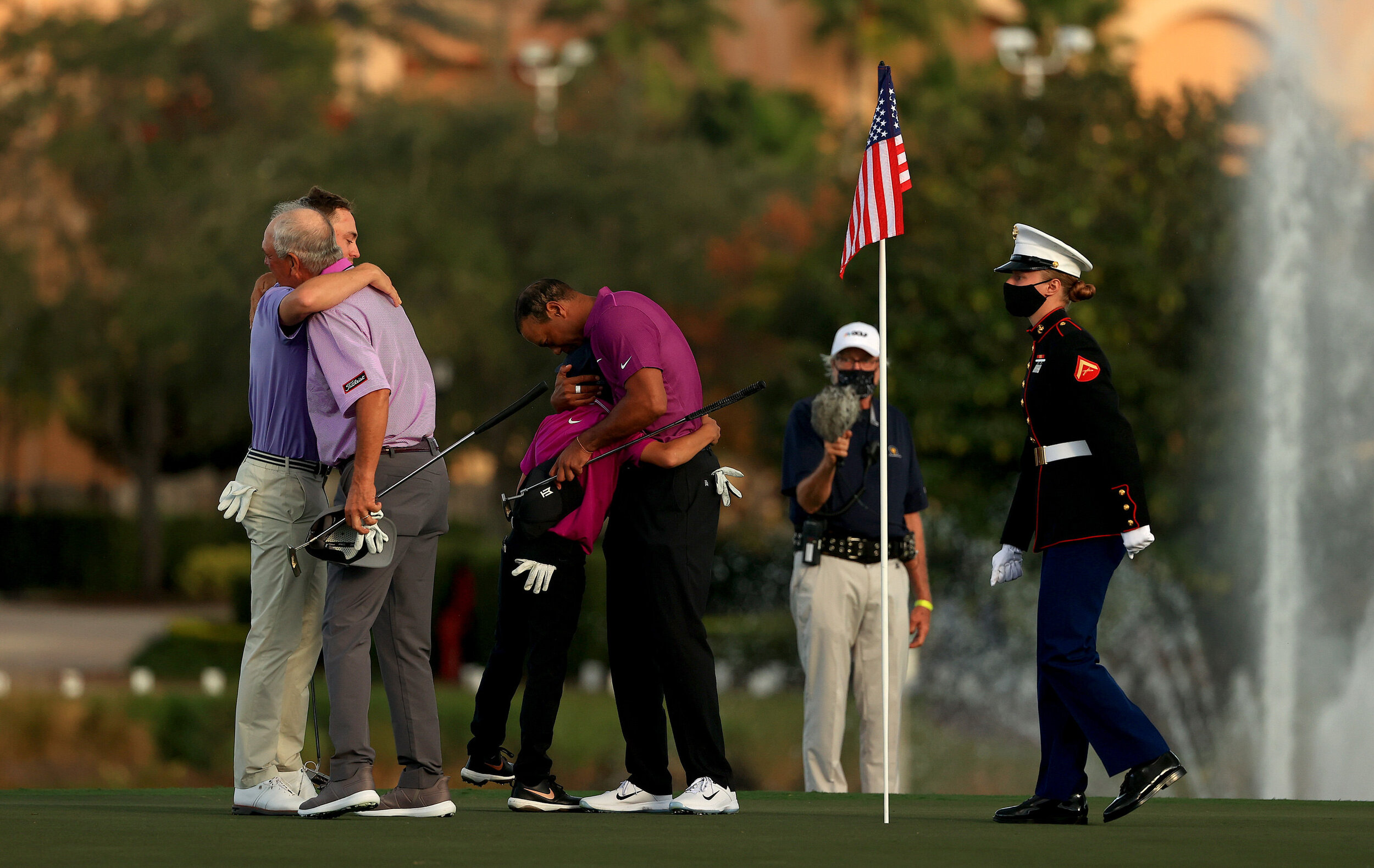  ORLANDO, FLORIDA - DECEMBER 19: Tiger Woods of the United States hugs son Charlie Woods as  Justin Thomas of the United States hugs dad Mike Thomas on the 18th hole during the first round of the PNC Championship at the Ritz Carlton Golf Club on Dece