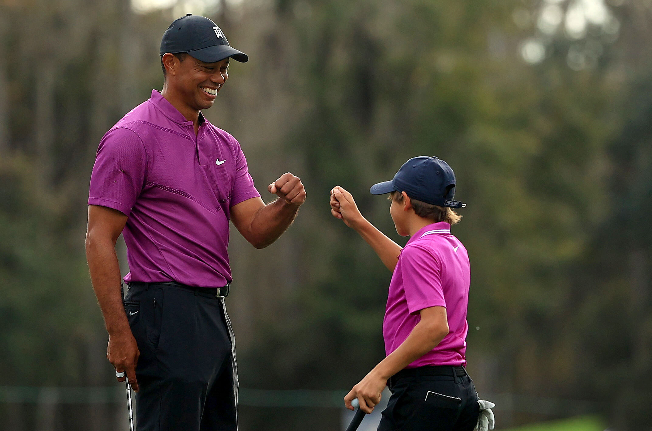  ORLANDO, FLORIDA - DECEMBER 19: Tiger Woods of the United States and son Charlie Woods high five after a birdie on the ninth hole during the first round of the PNC Championship at the Ritz Carlton Golf Club on December 19, 2020 in Orlando, Florida. 