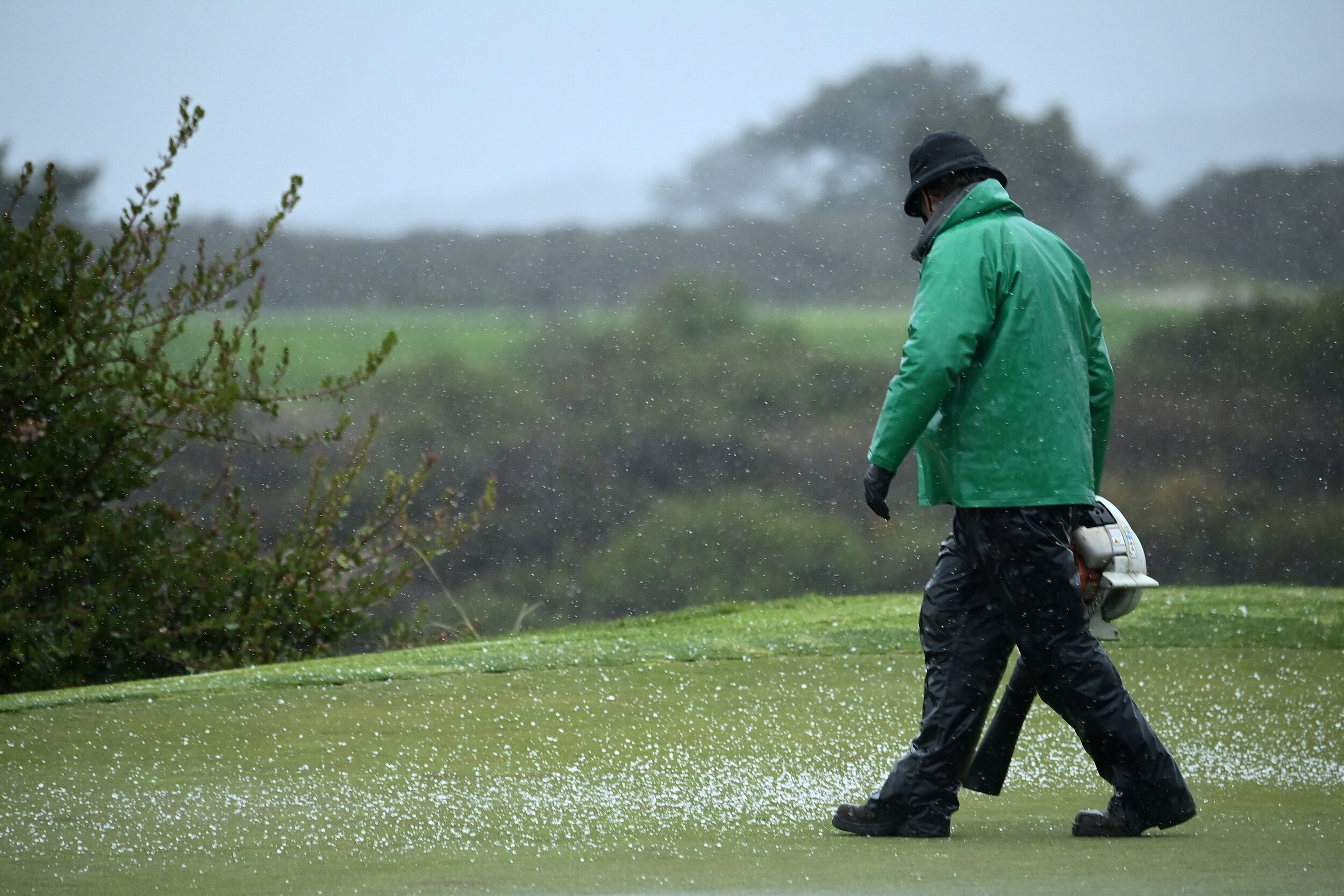  SAN DIEGO, CALIFORNIA - JANUARY 29: A groundskeeper clears hailstones off 17th hole green during round two of the Farmers Insurance Open at Torrey Pines on January 29, 2021 in San Diego, California. (Photo by Donald Miralle/Getty Images) 