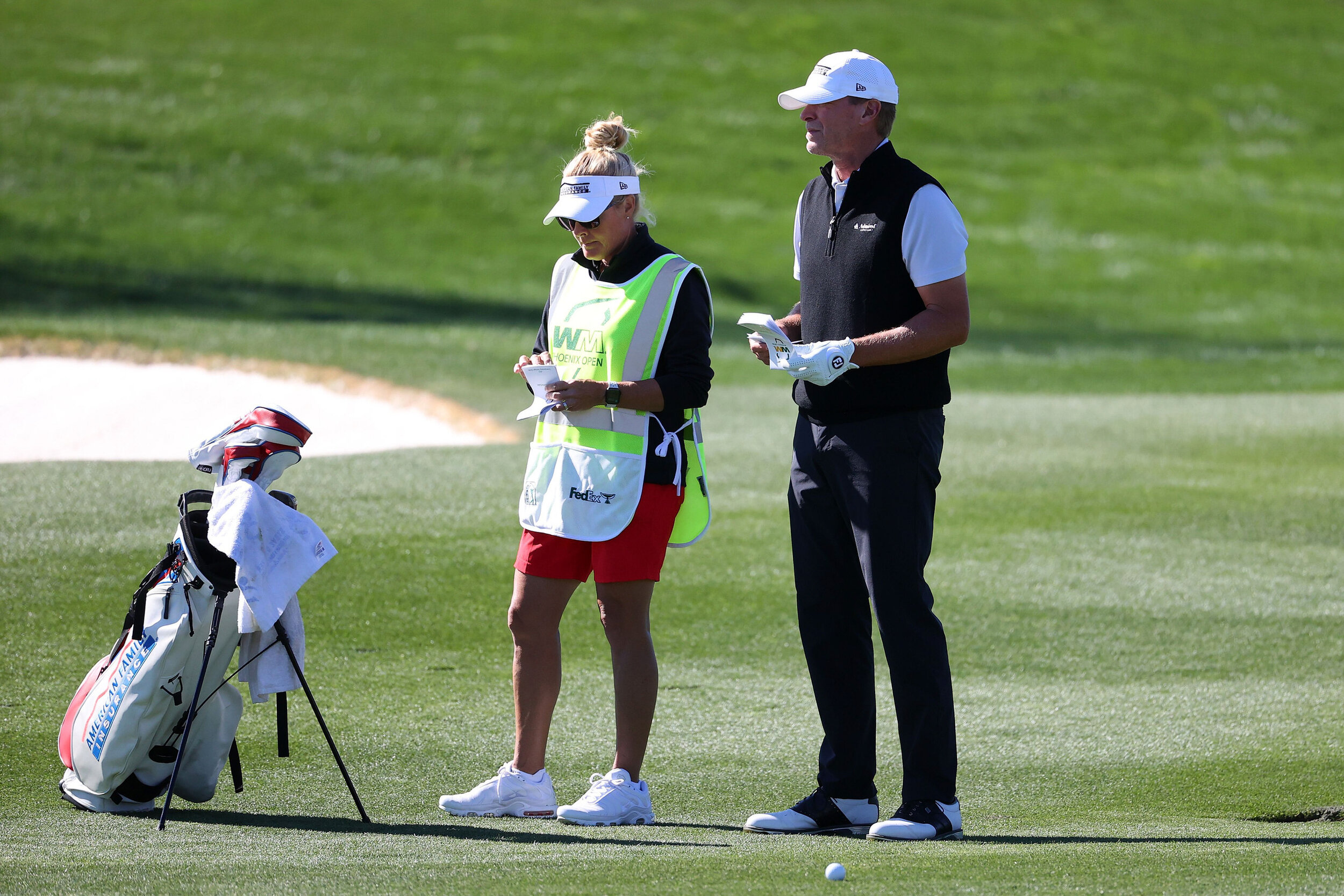  SCOTTSDALE, ARIZONA - FEBRUARY 05: Steve Stricker of the United States speaks with his caddie, Nicki Stricker, on the ninth hole during the second round of the Waste Management Phoenix Open at TPC Scottsdale on February 05, 2021 in Scottsdale, Arizo
