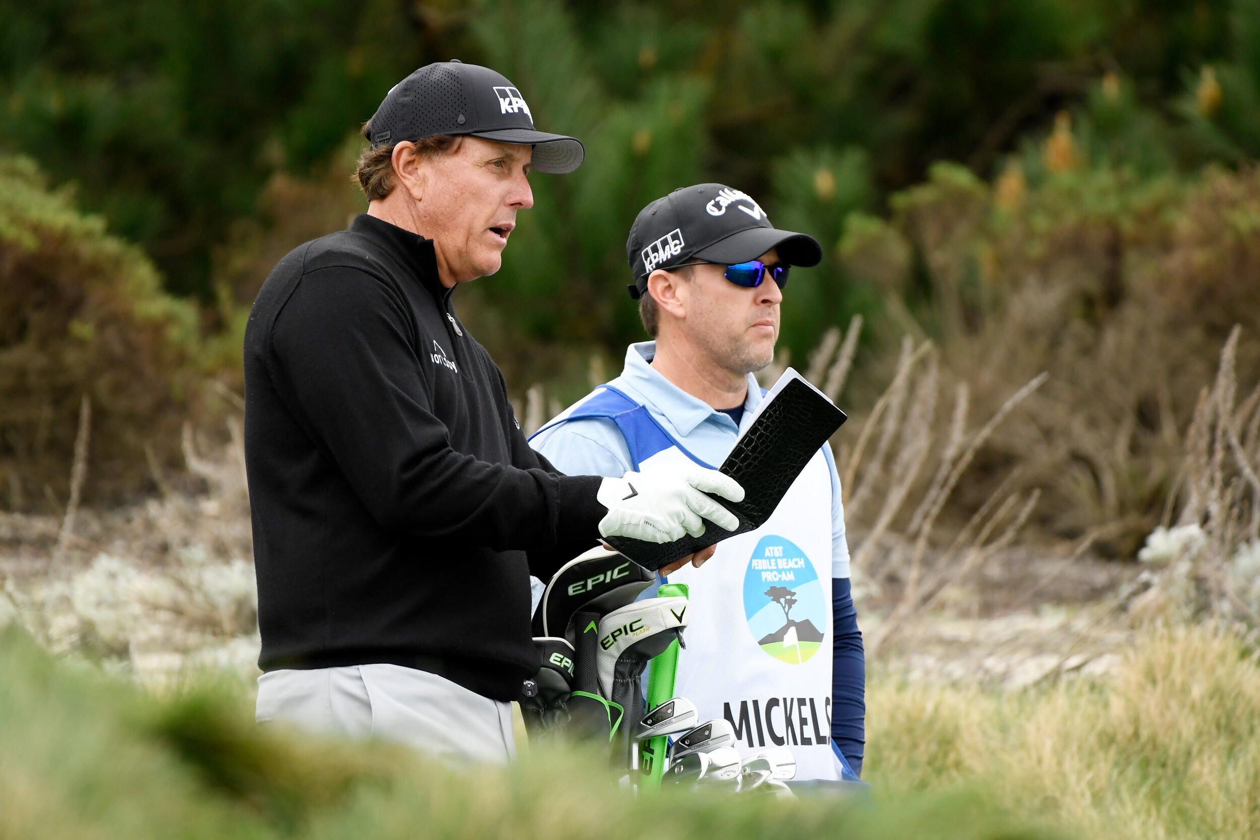  PEBBLE BEACH, CALIFORNIA - FEBRUARY 11: Phil Mickelson of the United States talks with his caddie and brother Tim Mickelson on the third hole during the first round of the AT&T Pebble Beach Pro-Am at Spyglass Hill Golf Course on February 11, 2021 in