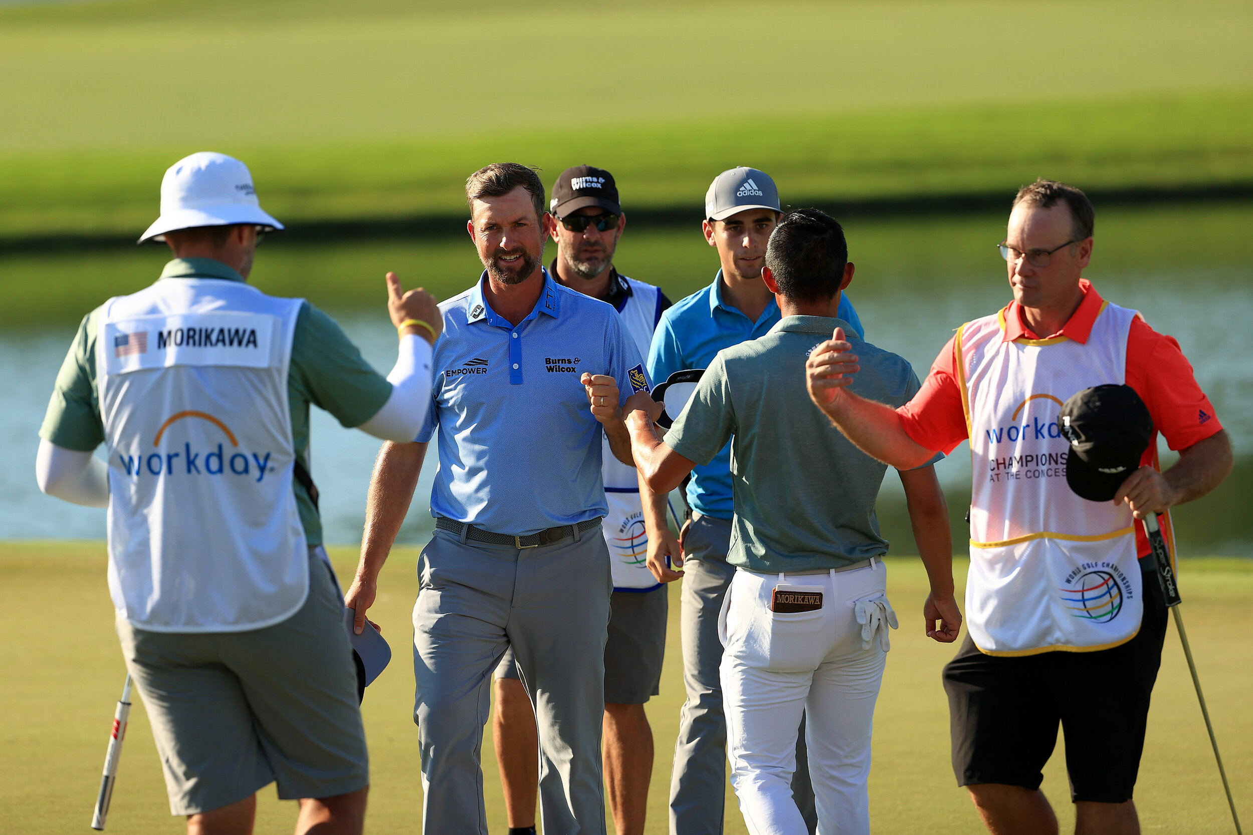 BRADENTON, FLORIDA - FEBRUARY 25: Webb Simpson of the United States and group shake hands on the 18th green after their first round of World Golf Championships-Workday Championship at The Concession on February 25, 2021 in Bradenton, Florida. (Photo