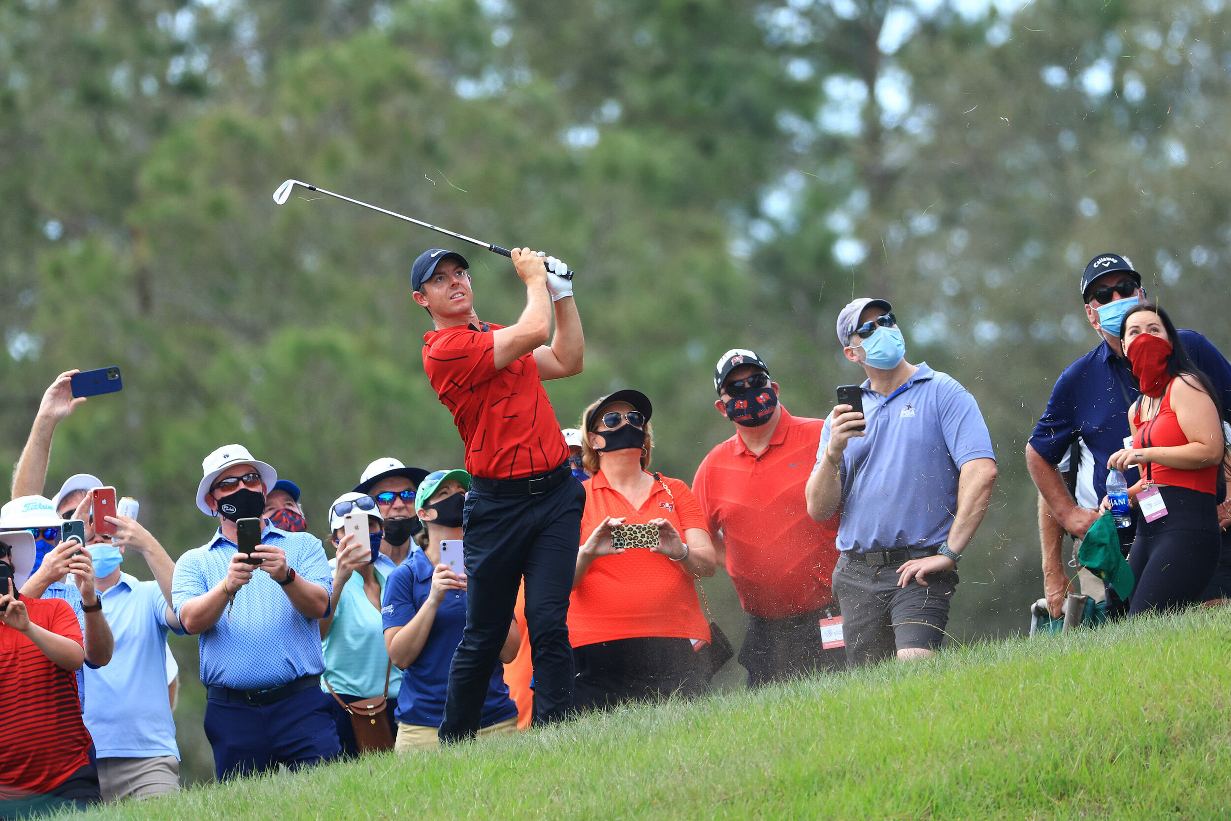  BRADENTON, FLORIDA - FEBRUARY 28: Fans watch as Rory McIlroy of Northern Ireland hits an approach shot on the seventh hole during the final round of World Golf Championships-Workday Championship at The Concession on February 28, 2021 in Bradenton, F
