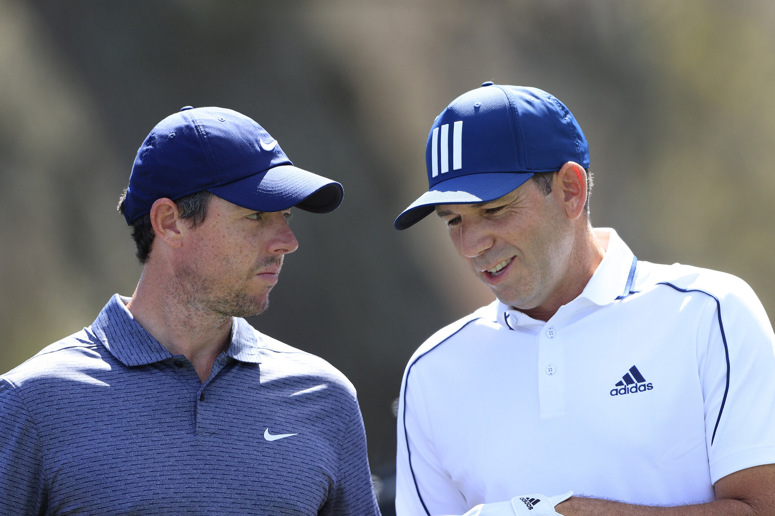  PONTE VEDRA BEACH, FLORIDA - MARCH 11: Rory McIlroy of Northern Ireland talks to Sergio Garcia of Spain during the first round of THE PLAYERS Championship on THE PLAYERS Stadium Course at TPC Sawgrass on March 11, 2021 in Ponte Vedra Beach, Florida.