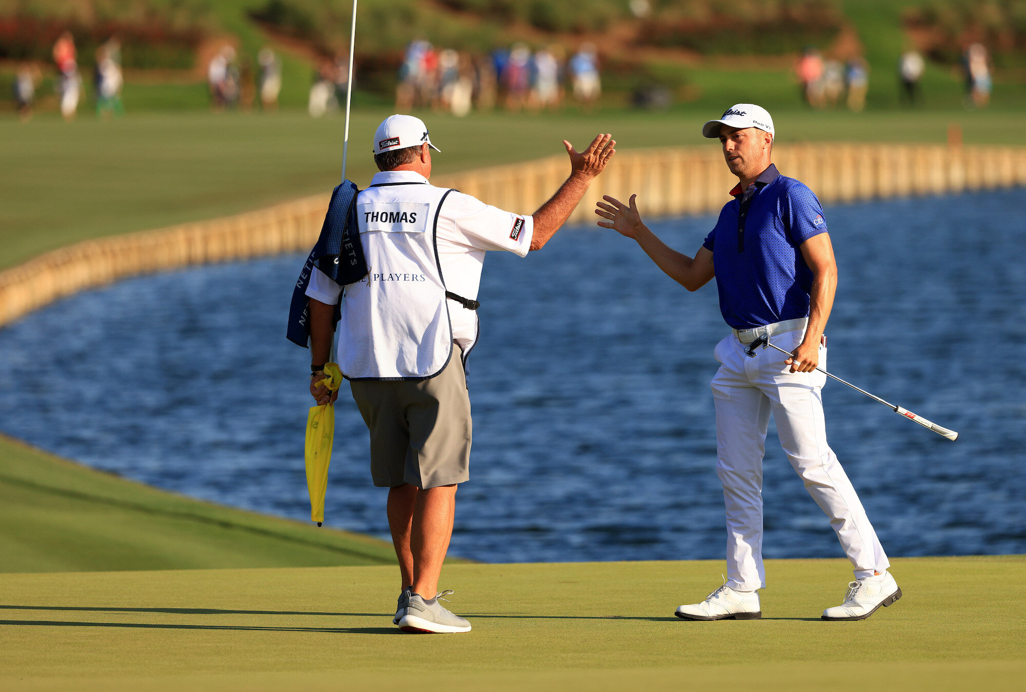  PONTE VEDRA BEACH, FLORIDA - MARCH 14: Justin Thomas of the United States celebrates with his caddie Jimmy Johnson after finishing on the 18th green on his way to winning during the final round of THE PLAYERS Championship on THE PLAYERS Stadium Cour