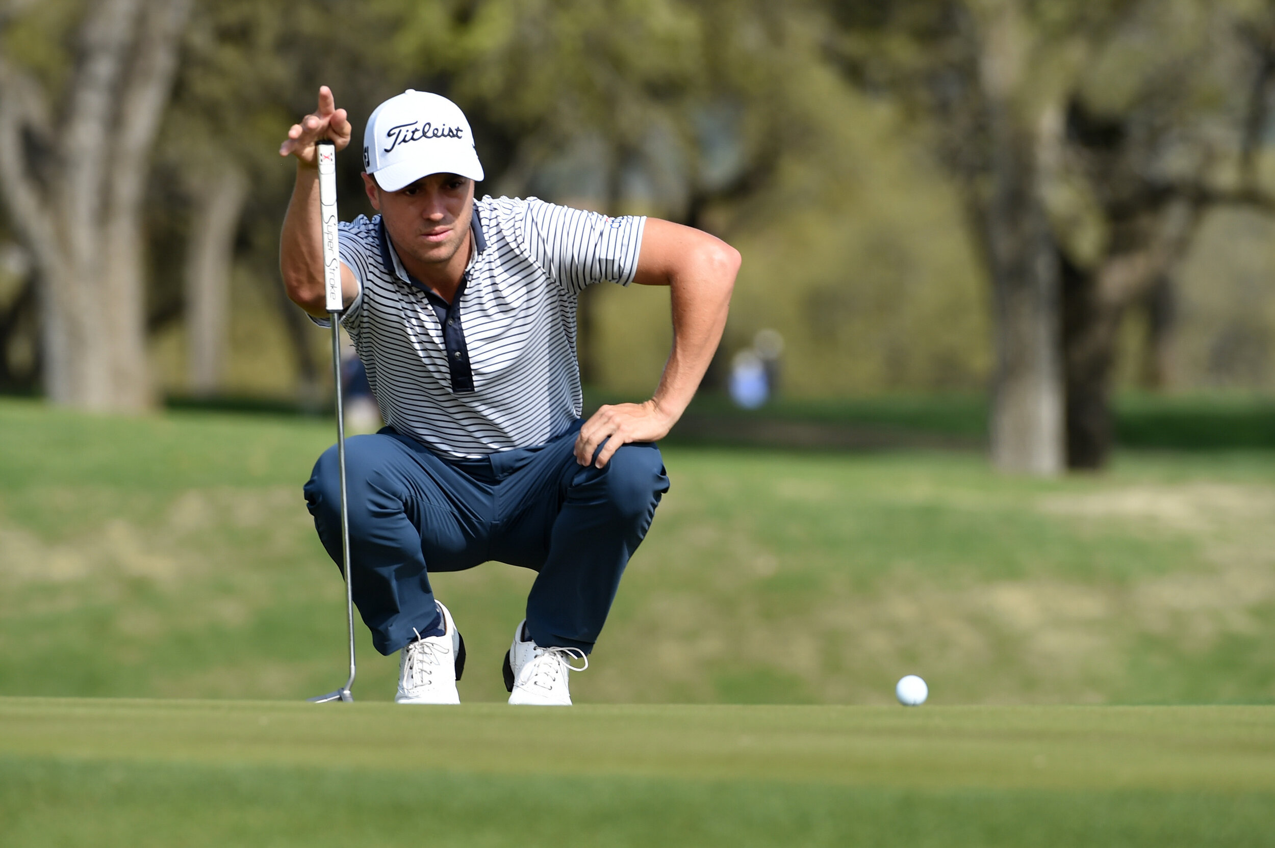  AUSTIN, TEXAS - MARCH 24: Justin Thomas of the United States lines up his putt on the first green in his match against Matt Kuchar of the United States during the first round of the World Golf Championships-Dell Technologies Match Play at Austin Cou