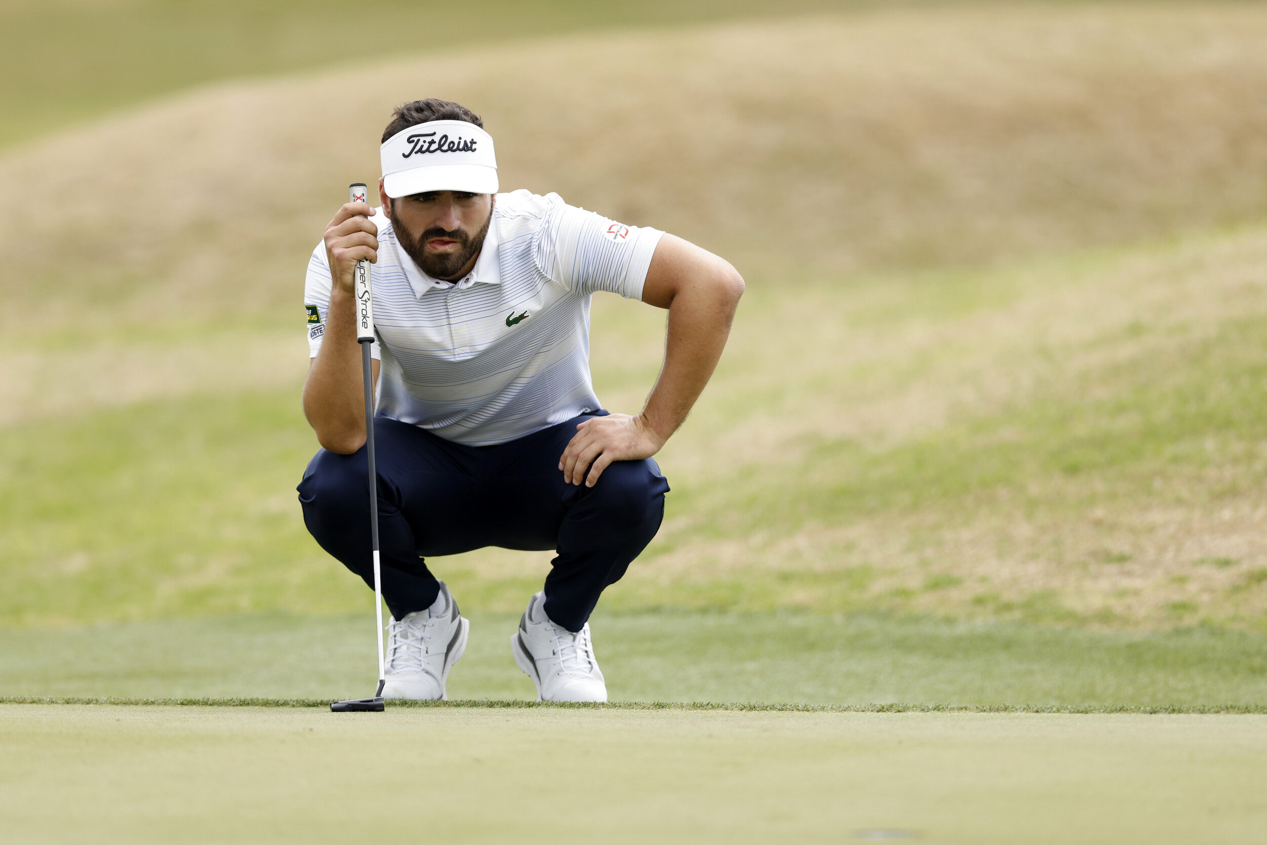  AUSTIN, TEXAS - MARCH 24: Antoine Rozner of France lines up a putt on the 15th green in his match against Bryson DeChambeau of the United States during the first round of the World Golf Championships-Dell Technologies Match Play at Austin Country Cl