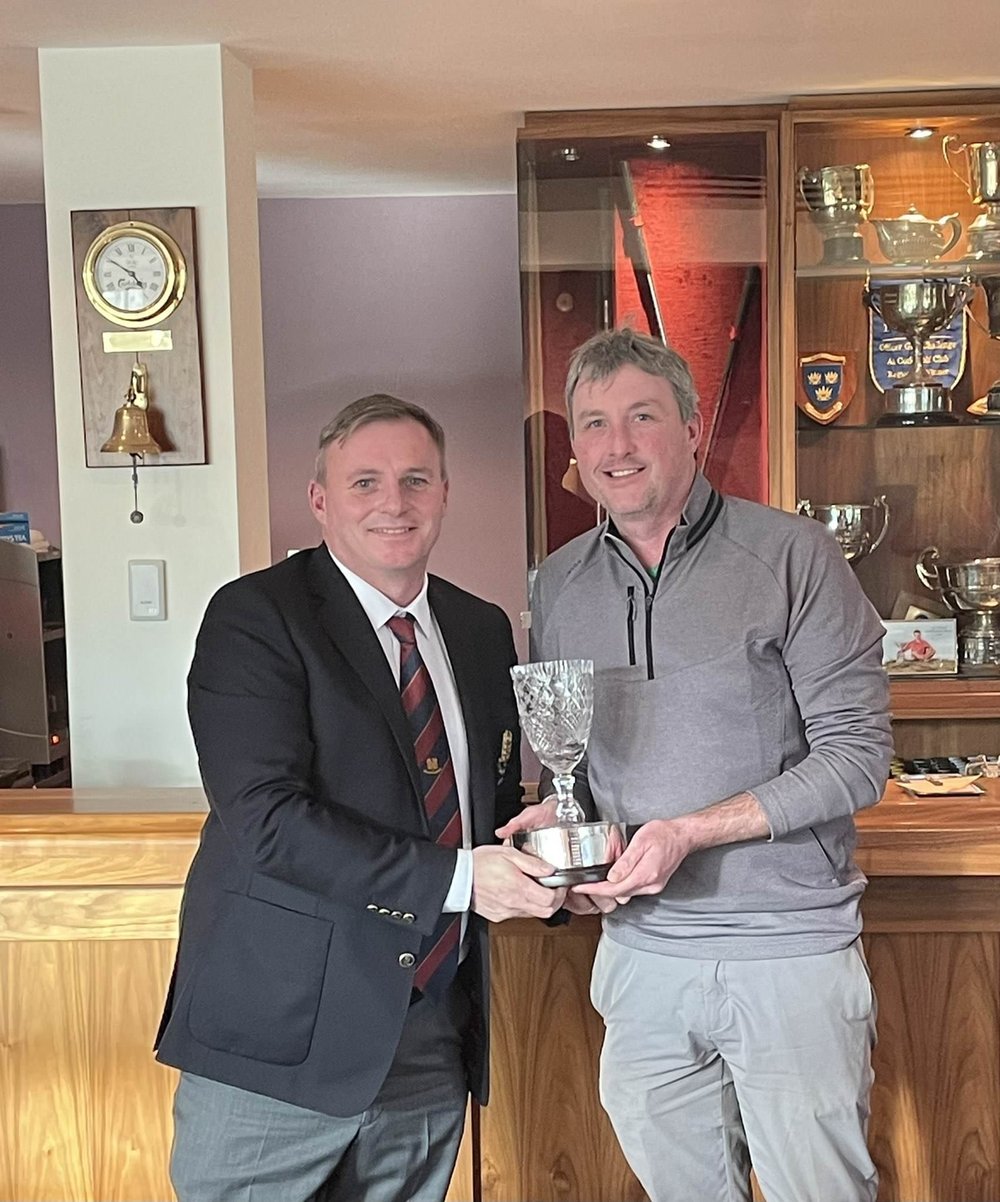 Monkstown Golf Club captain Donal Delaney presents the 2021 Southern Championship to East Cork's David Ryan