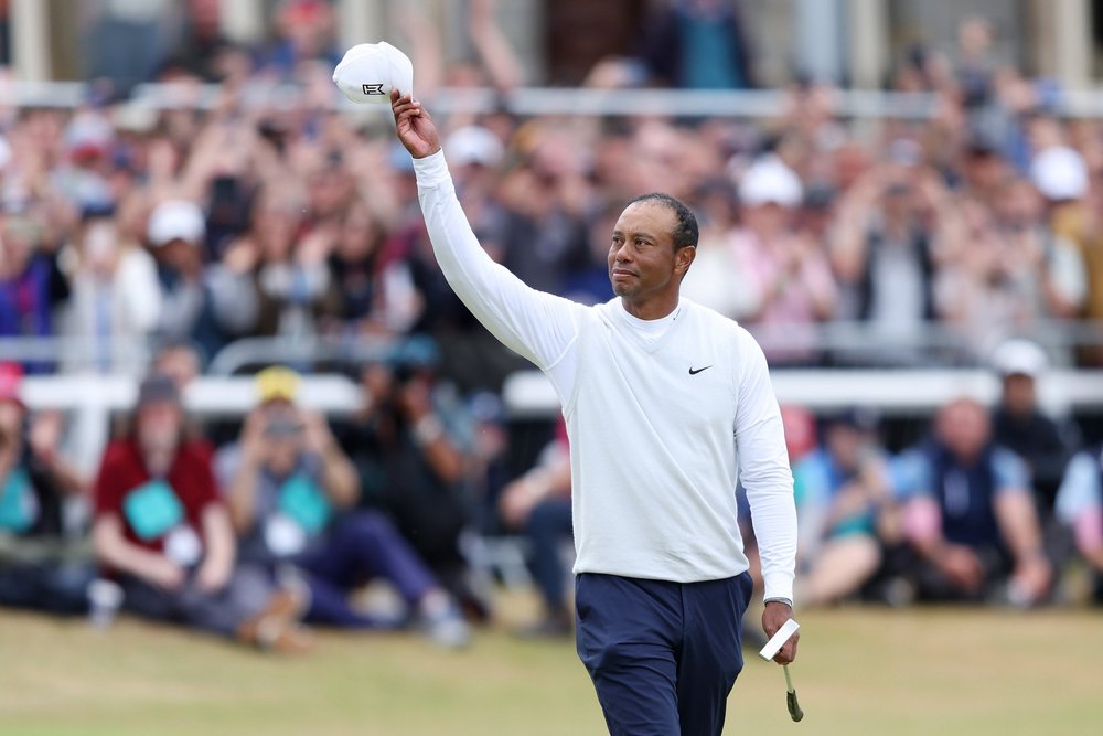 ST ANDREWS, SCOTLAND - JULY 15: Tiger Woods of the United States acknowledges the crowd on the 18th hole during Day Two of The 150th Open at St Andrews Old Course on July 15, 2022 in St Andrews, Scotland. (Photo by Richard Heathcote/R&A/R&A via Getty