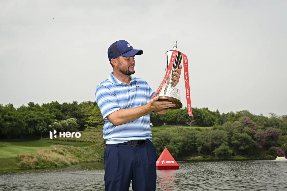 Alex Fitzpatrick admires the Hero Indian Open trophy