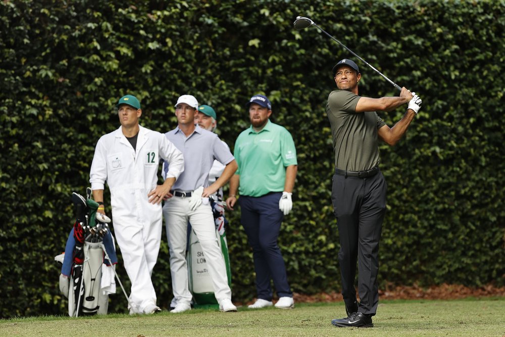 Shane Lowry looks on as Masters champion Tiger Woods plays his stroke from the No. 2 tee during Round 1 of the Masters at Augusta National Golf Club, Thursday, November 12, 2020.