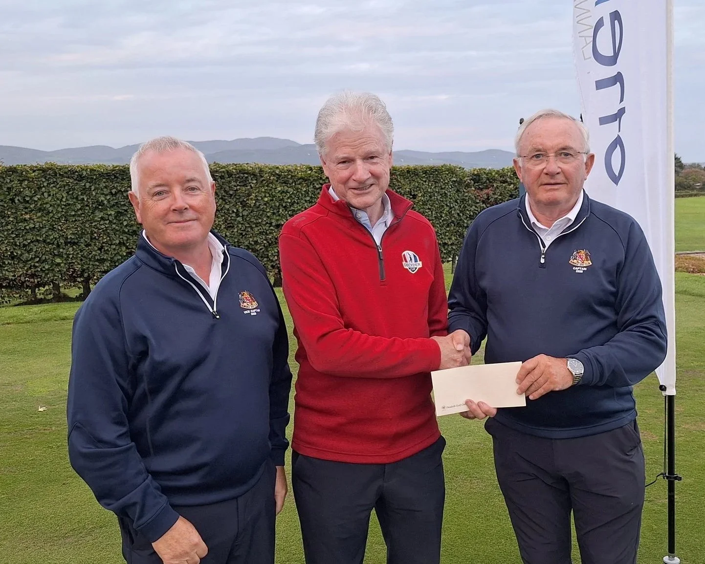 Dundalk Golf Club Captain Michael O'Sullivan and Vice-Captain Martin McDonnell make a special presentation to Peter Rogers to mark his 50th appearance in the One Finance Dundalk Scratch Cup.