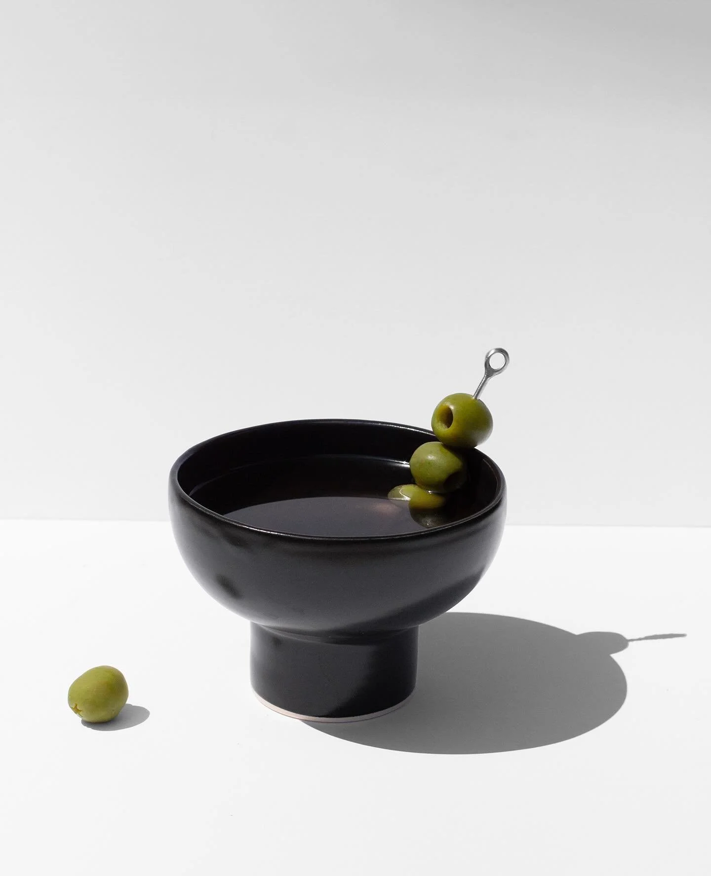 You all have loved the Stemless Martini Glasses so much, I thought I&rsquo;d offer a sexy new version! This cocktail glass has the perfect sunken curved shape and silky black glaze to show off your favorite bev. Now live!