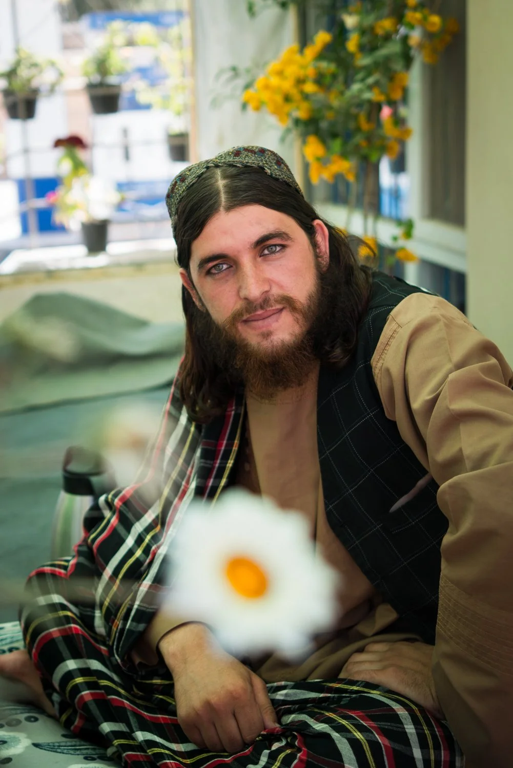  Sifutallah Shahid Omari, a Taliban soldier, takes tea in a flower shop near Bamiyan 