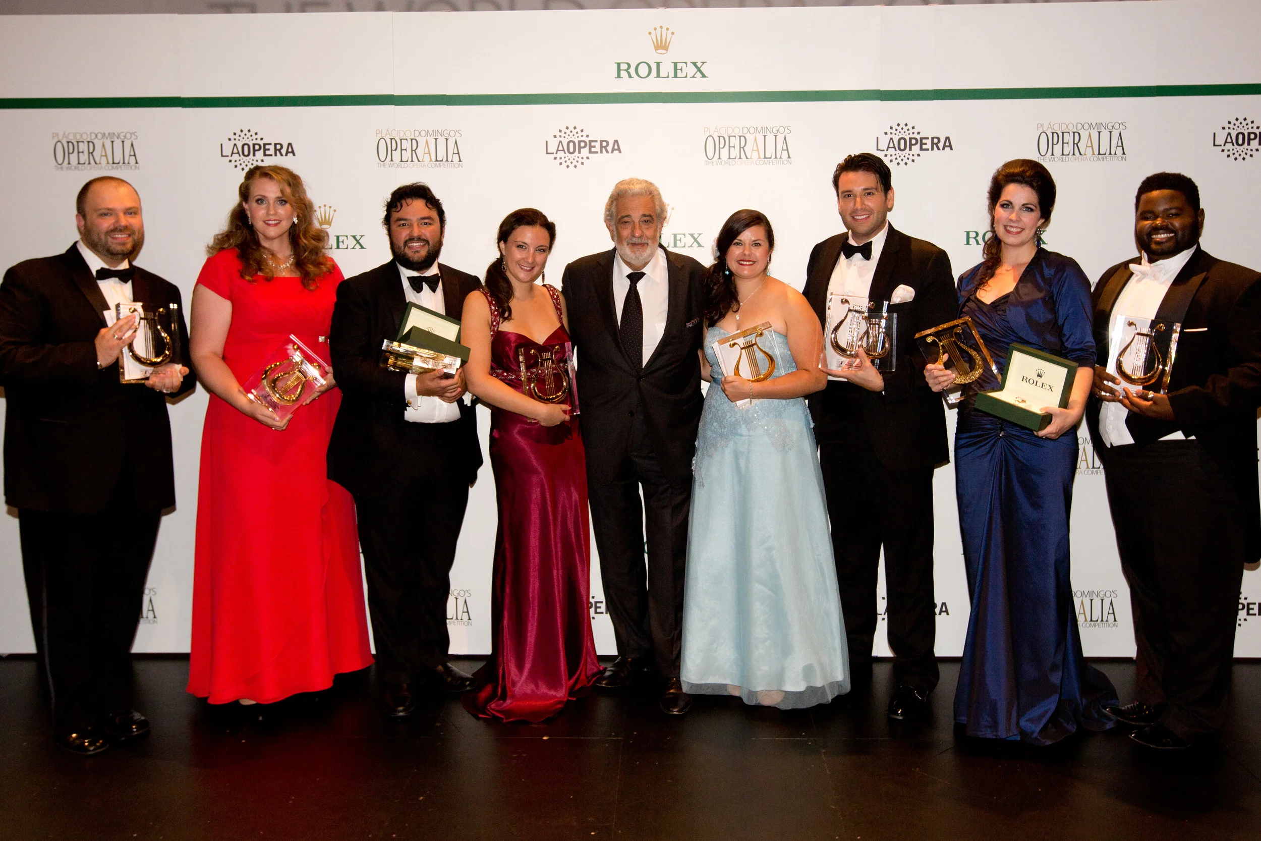 Left to right: Andrey Nemzer, Rachel Willis-Sorensen, Mario Chang, Mariangela Sicilia, Placido Domingo, Anais Constans, Joshua Guerrero, Amanda Woodbury, John Holiday. — Photo: Craig Mathew / LA Opera