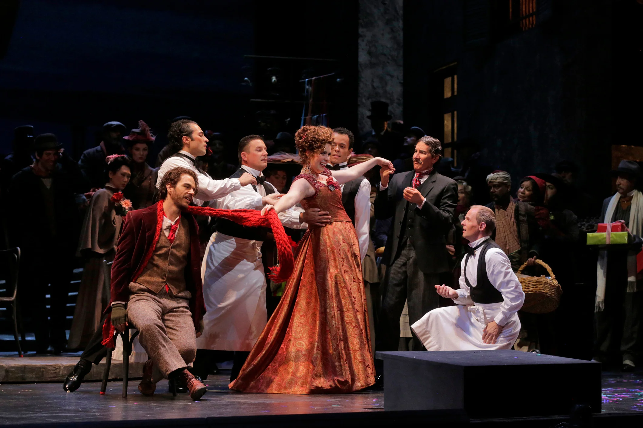 Musetta (Amanda Woodbury) and her helpless admirers. — Photography by Ken Howard