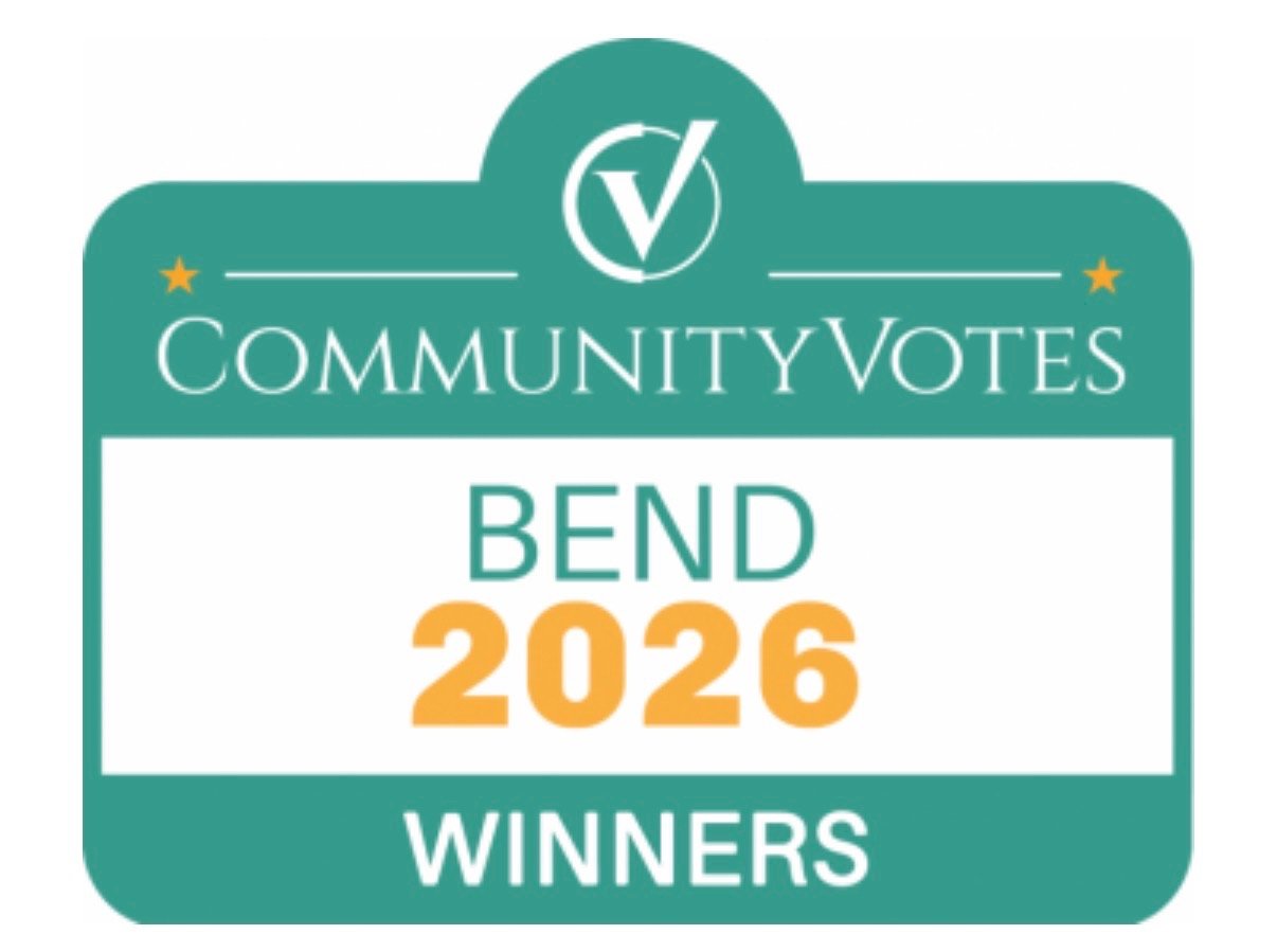 A badge with a teal background and a white border, displaying the text 'Community Votes Bend 2026 Winners' and a checkmark logo at the top.