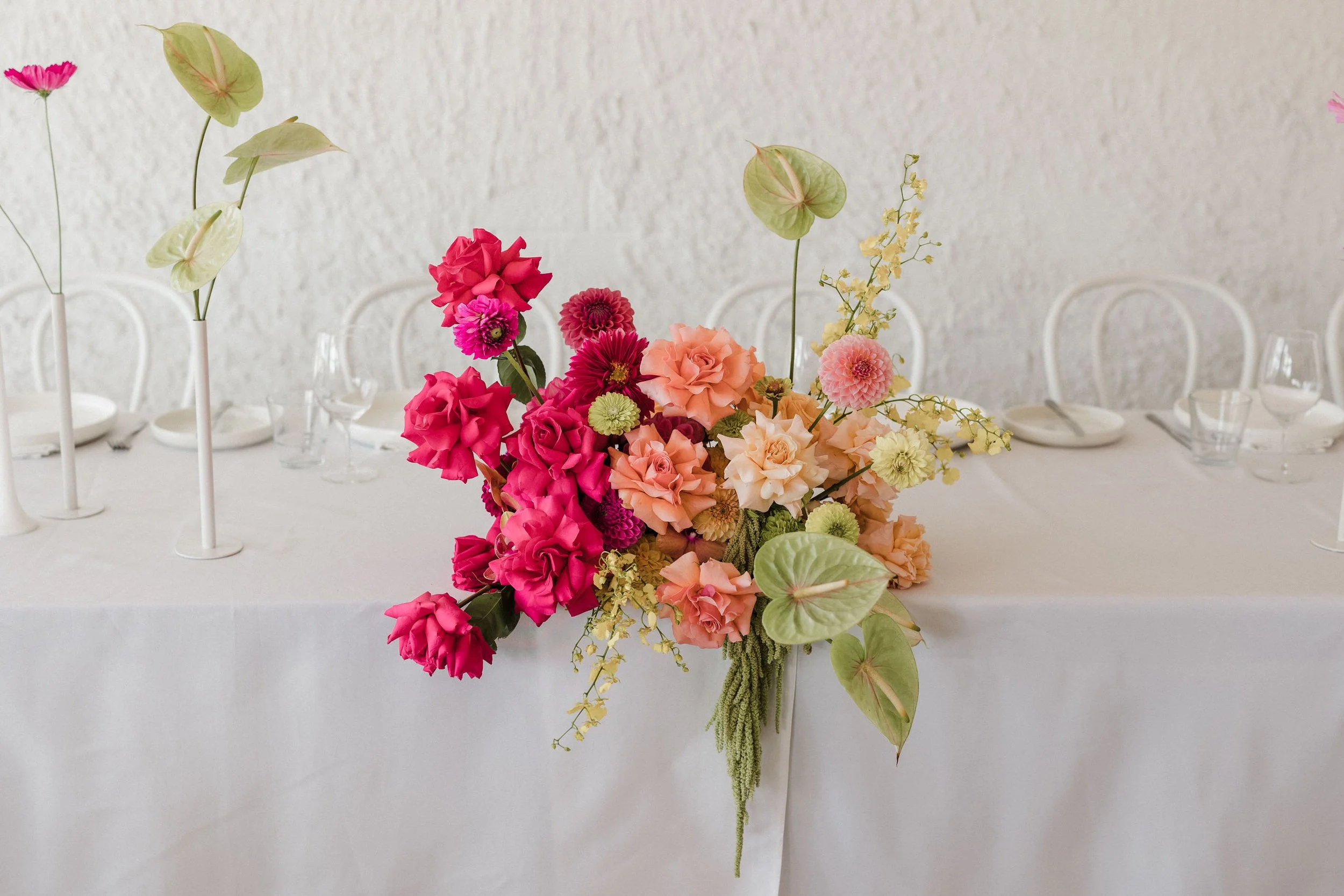 36 Simon Hacket Winery Wedding Reception bright florals.jpg