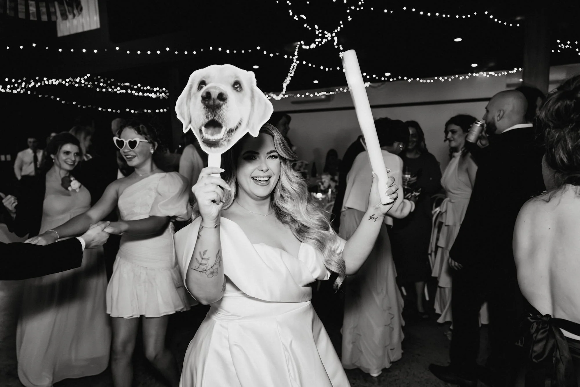 A bride dancing with props during her wedding reception in adelaide