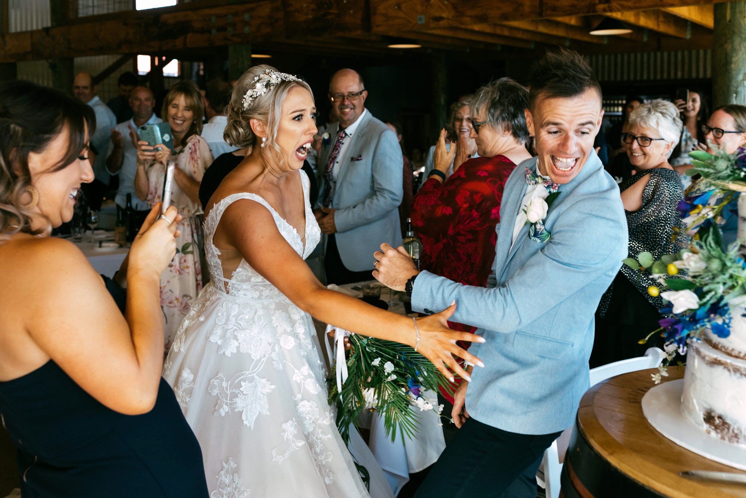 Funny 404 page not found wedding photos - bride yelling "noooo"! and reaching for her groom as he smiles and nearly walks backwards into the wedding cake.