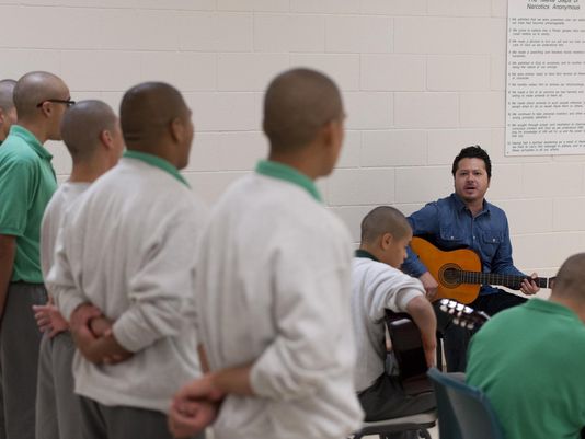 Carlos Rodriguez of Mezcal teaches guitar to youth at Tulare County Probation Youth Facility on Monday, December 14, 2015. Students must behave in and out of all classes to participate in the extracurricular activity. (Photo: Ron Holman)