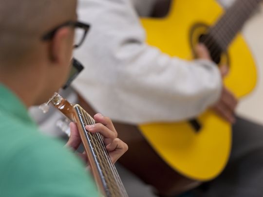Youth at Tulare County Probation Youth Facility learn guitar from Carlos Rodriguez of Mezcal on Monday, December 14, 2015. Students must behave in and out of all classes to participate in the extracurricular activity. (Photo: Ron Holman)