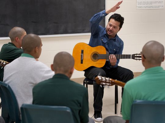 Carlos Rodriguez of Mezcal teaches guitar to youth at Tulare County Probation Youth Facility on Monday, December 14, 2015. Students must behave in and out of all classes to participate in the extracurricular activity. (Photo: Ron Holman)