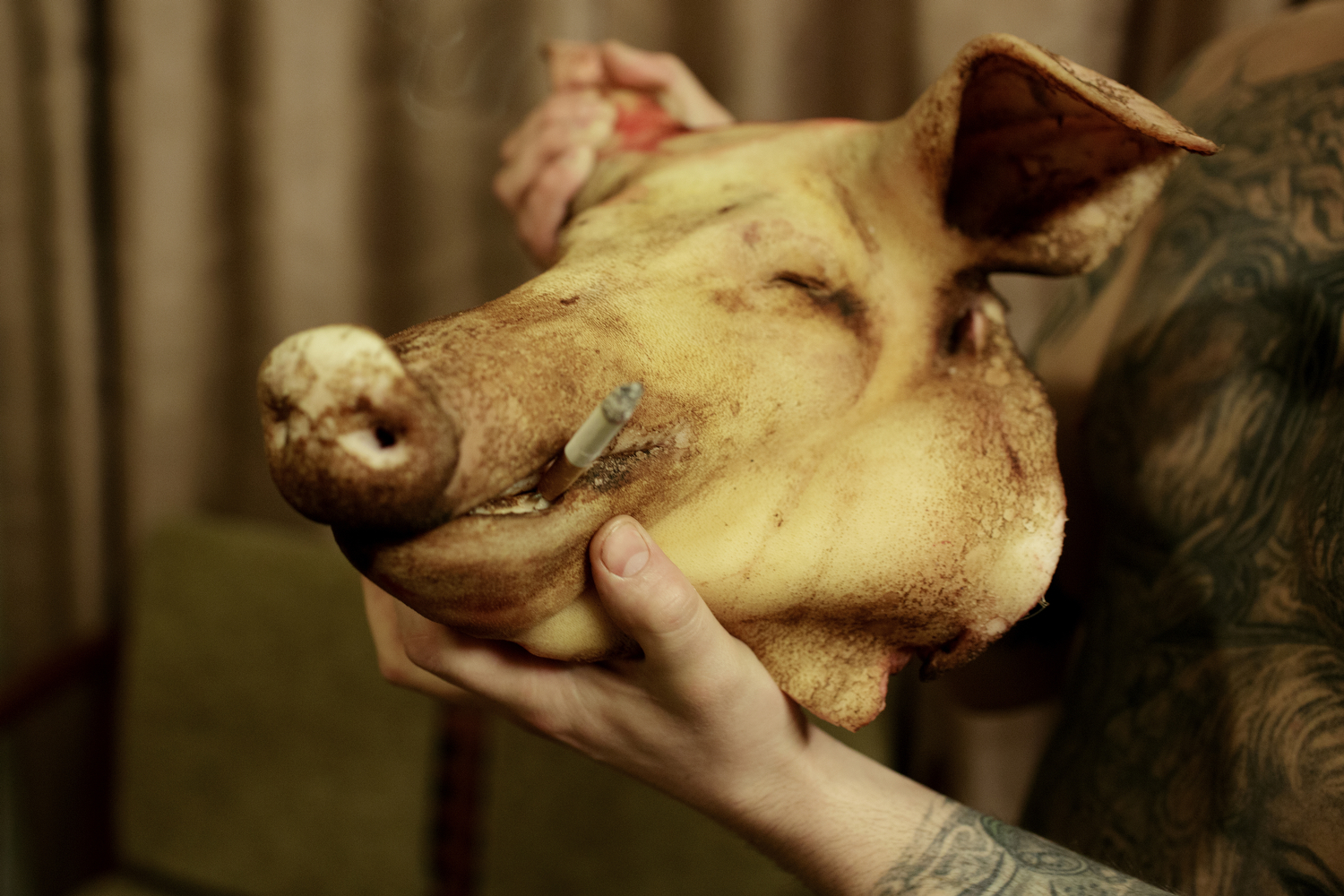     A worker has bought a pig's head at the local store.    