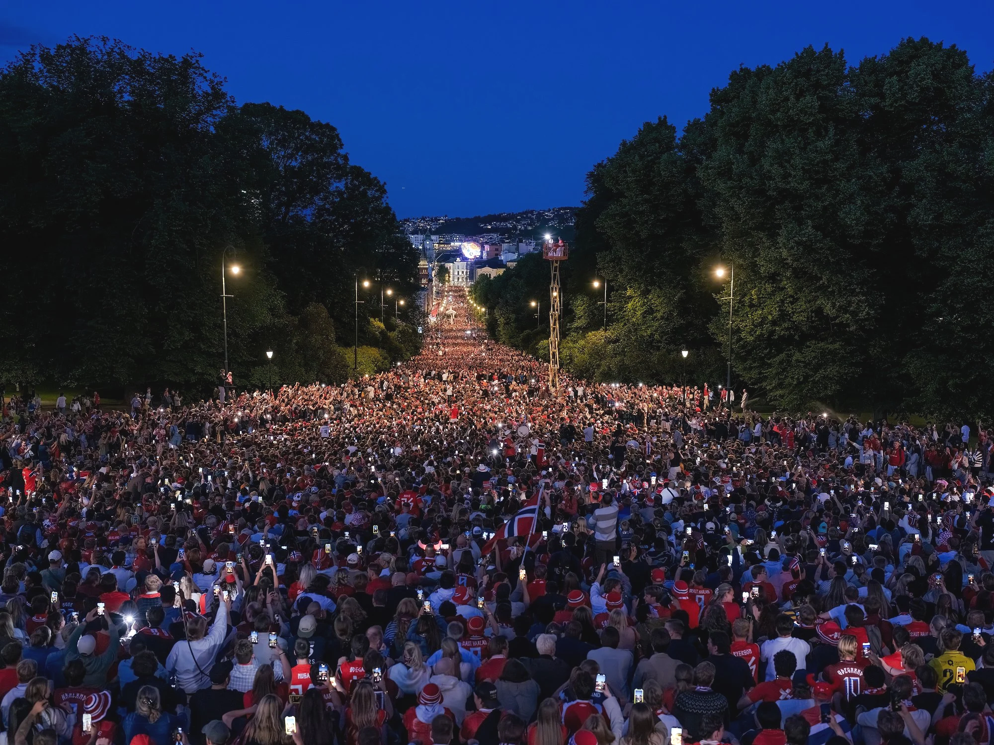   A State of National Emergency   During the 2026 FIFA World Cup, I photographed people in Norway gathering to watch football.  In Norway, the matches appeared as light on large screens: in tents, bars, temporary outdoor arenas, in public squares, an