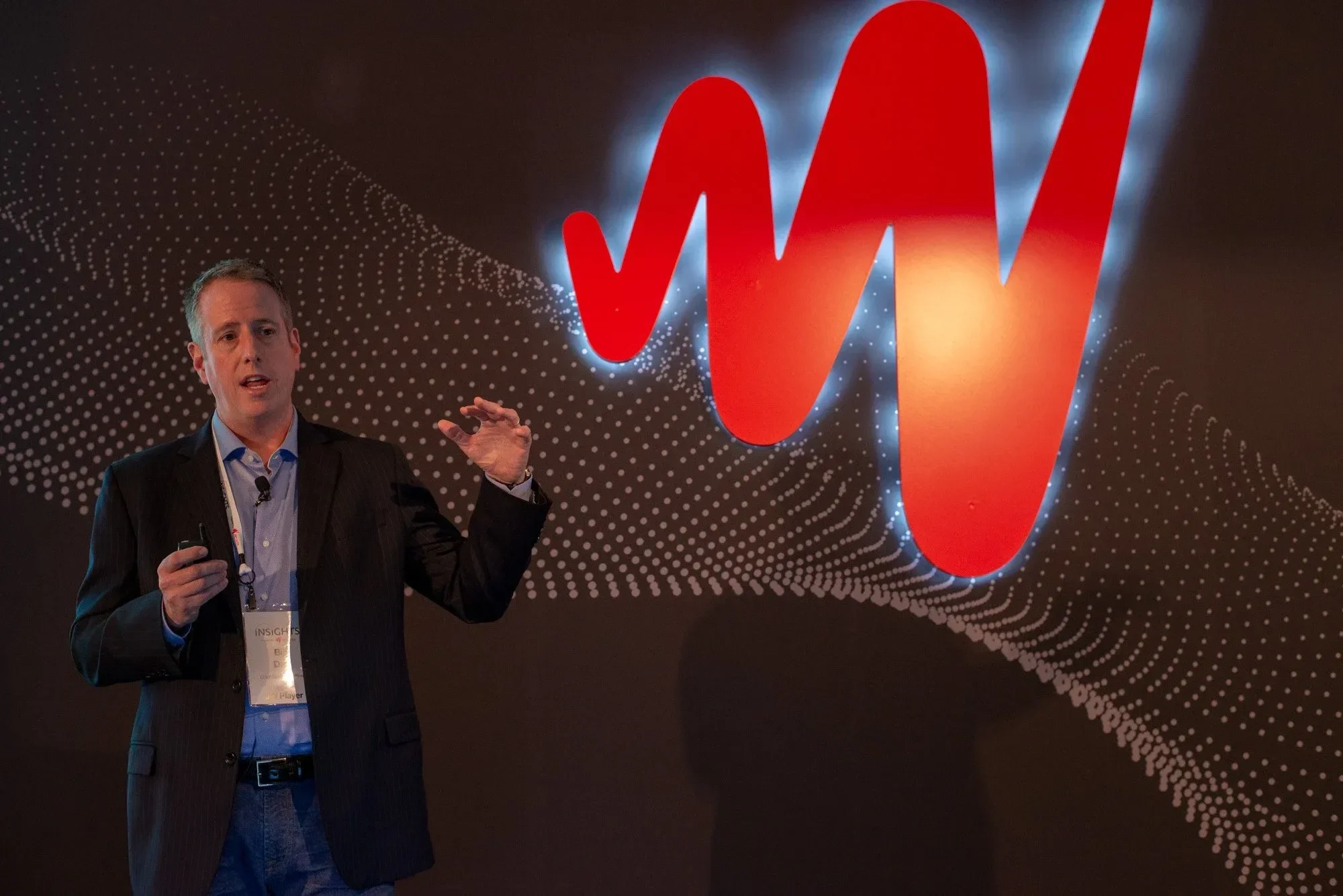 3D lit logomark on stage