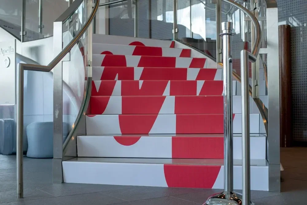 Logo printed on stair fronts for  parallax effect