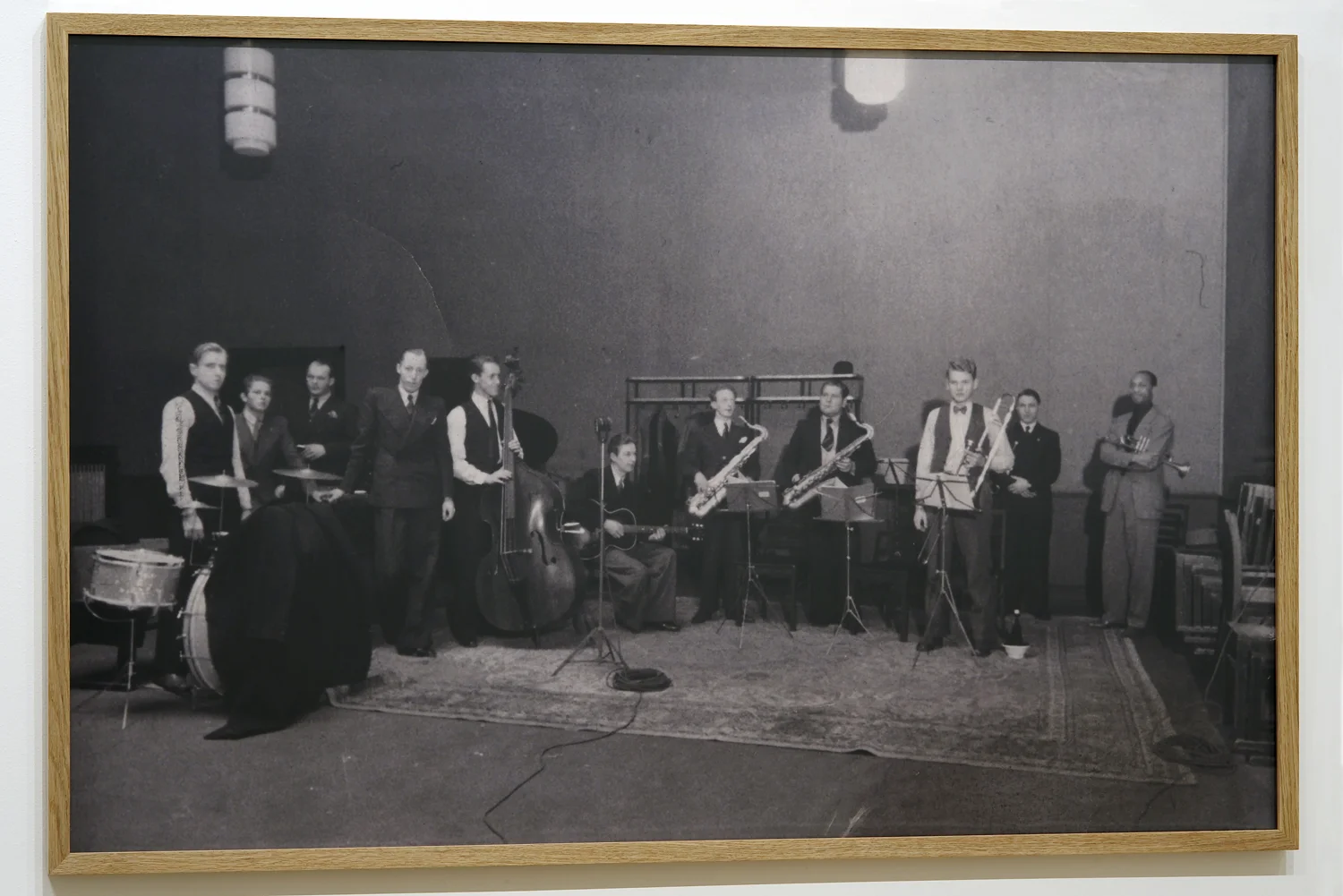 ”Oslo, February 14, 1940, recording at Vitenskapsakademiet” digital print, 83 x 126 cm (Photographer unknown, source: Norwegian Jazz archive) (from left: Stein Lorentzen, Fren Dahl, Jens Magnus Jenssen, Nils Jacob Jacobsen, Fred Lange-Nielsen, Robert Normann, Per Nilsen, Arvid Grahm Paulsen, Ivan Jacobsen, Rowland Greenberg, Jacques Butler)