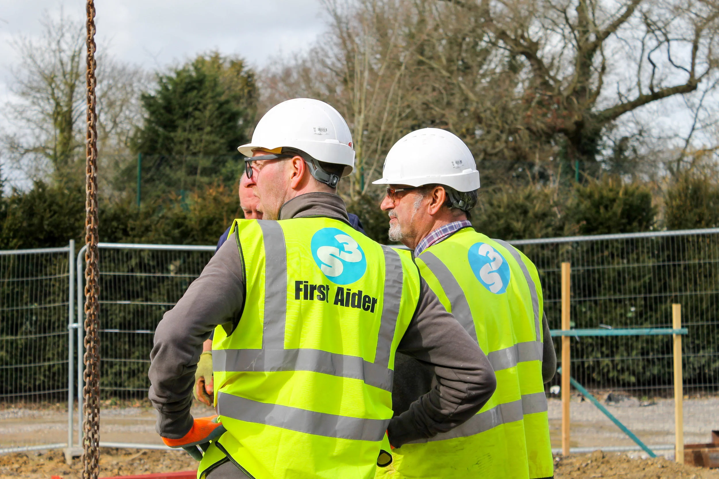 Site managers Dick and Jim consulting a contractor on site.