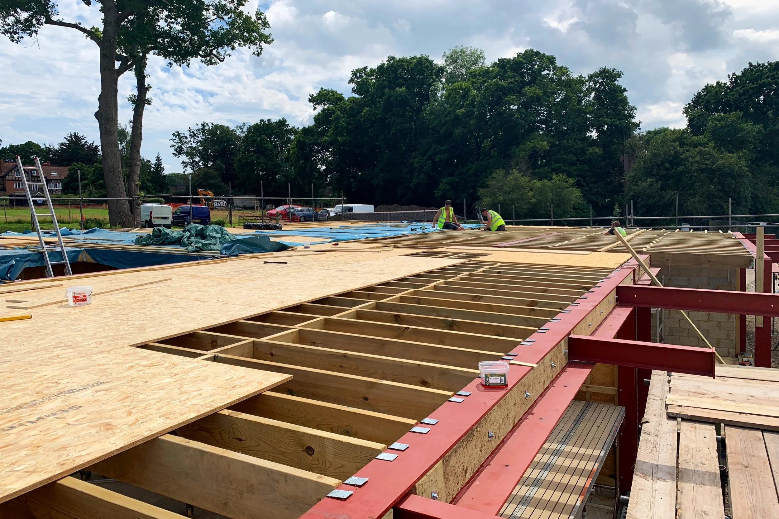 Luke bolting joists and nailing jiffy hangers