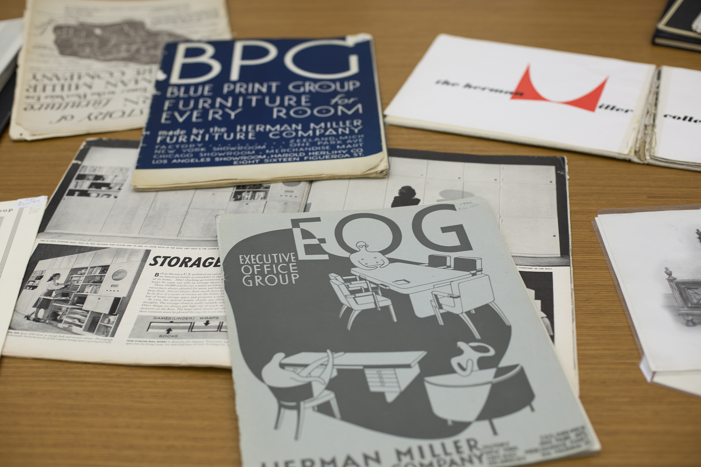 A survey of Herman Miller catalogues. To the right hand corner is the famous hardcover product catalog designed and written by George Nelson from 1948. In the foreground is Life Magazine's article on Nelson and his Storagewall Design. It caught D.J. De Pree's eye in 1945. Photograph by Martha Morimoto.