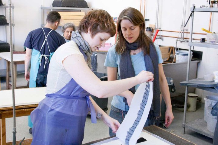 Book & Paper alumna, Kaitlin Kostus (left) works on one of Sheroanawë Hakihiiwë's edition images.