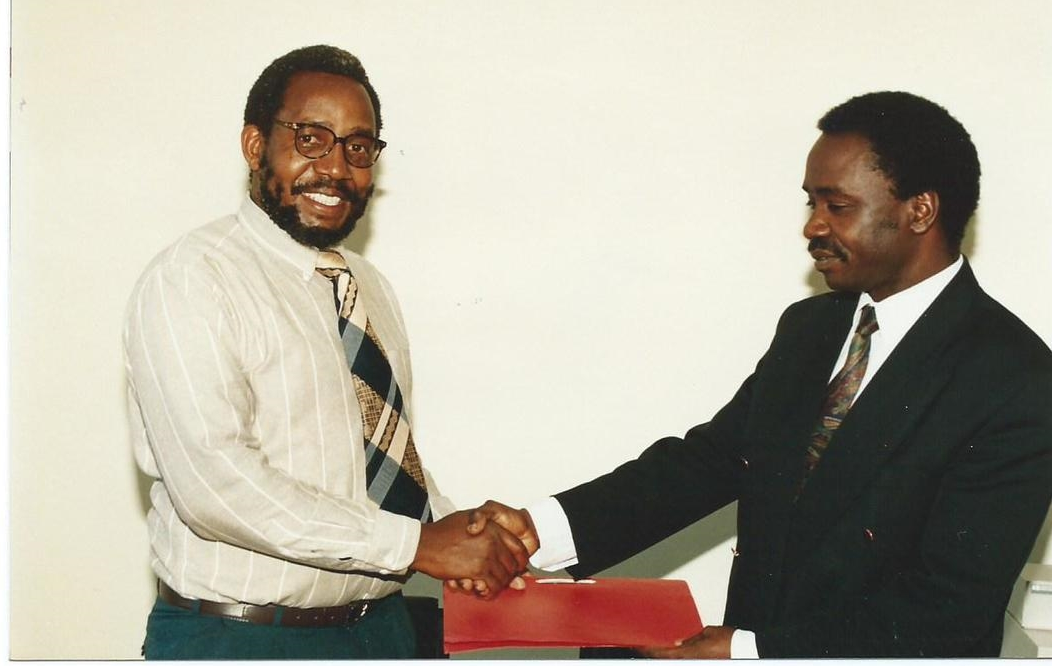 Dr. Alfred Latigo and Dr. Frank Mosha Exchanging an Agreement on Collaborative Biodiversity Prospecting Research Project between the Tropical Pesticide Research Institute (TPRI), Tanzania and ABI-GIDE (1995)