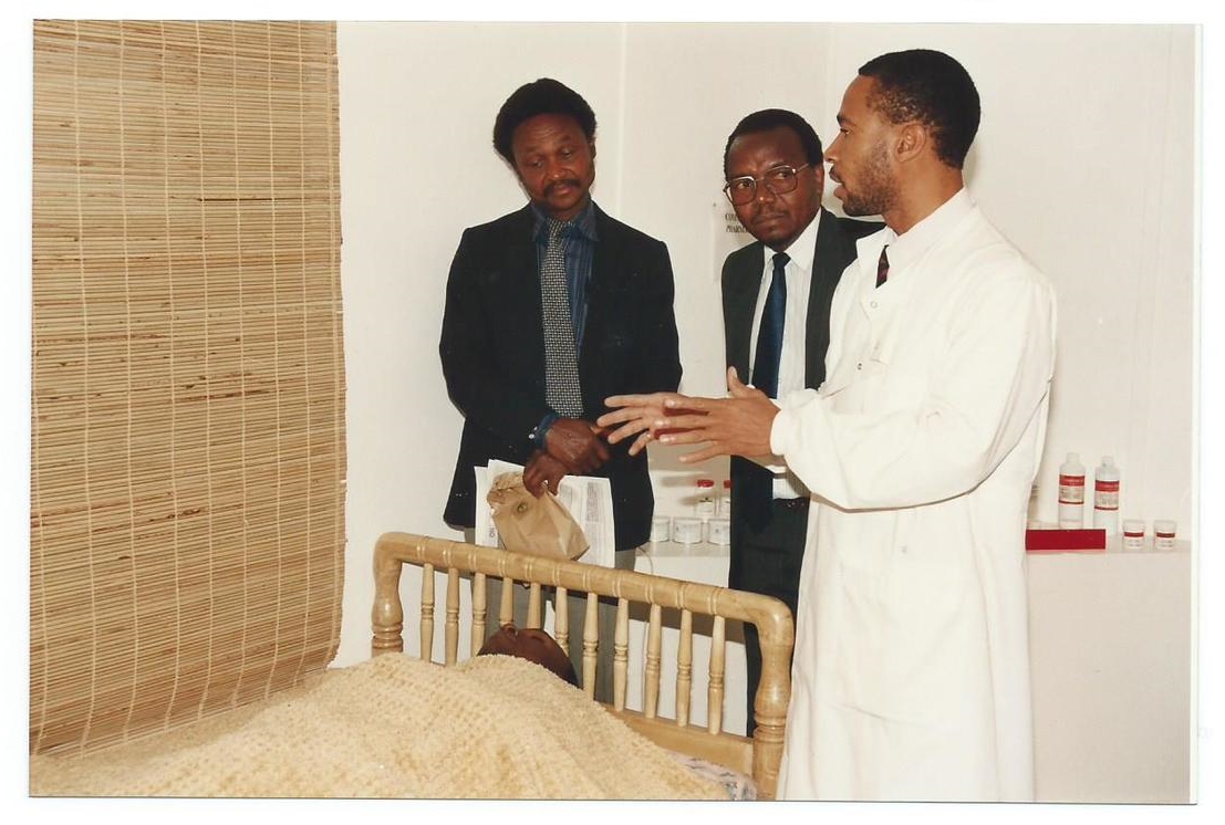 Dr. N. Nwoke, GIDE Researcher Demonstrates How GIDE’s Affordable Technology of Papyrus Impregnated Papyrus Mat (left) is Used on the Wall in a Bed Room for Controlling Mosquitoes in East Africa. Note Person Protected is Lying Peacefully in Bed!