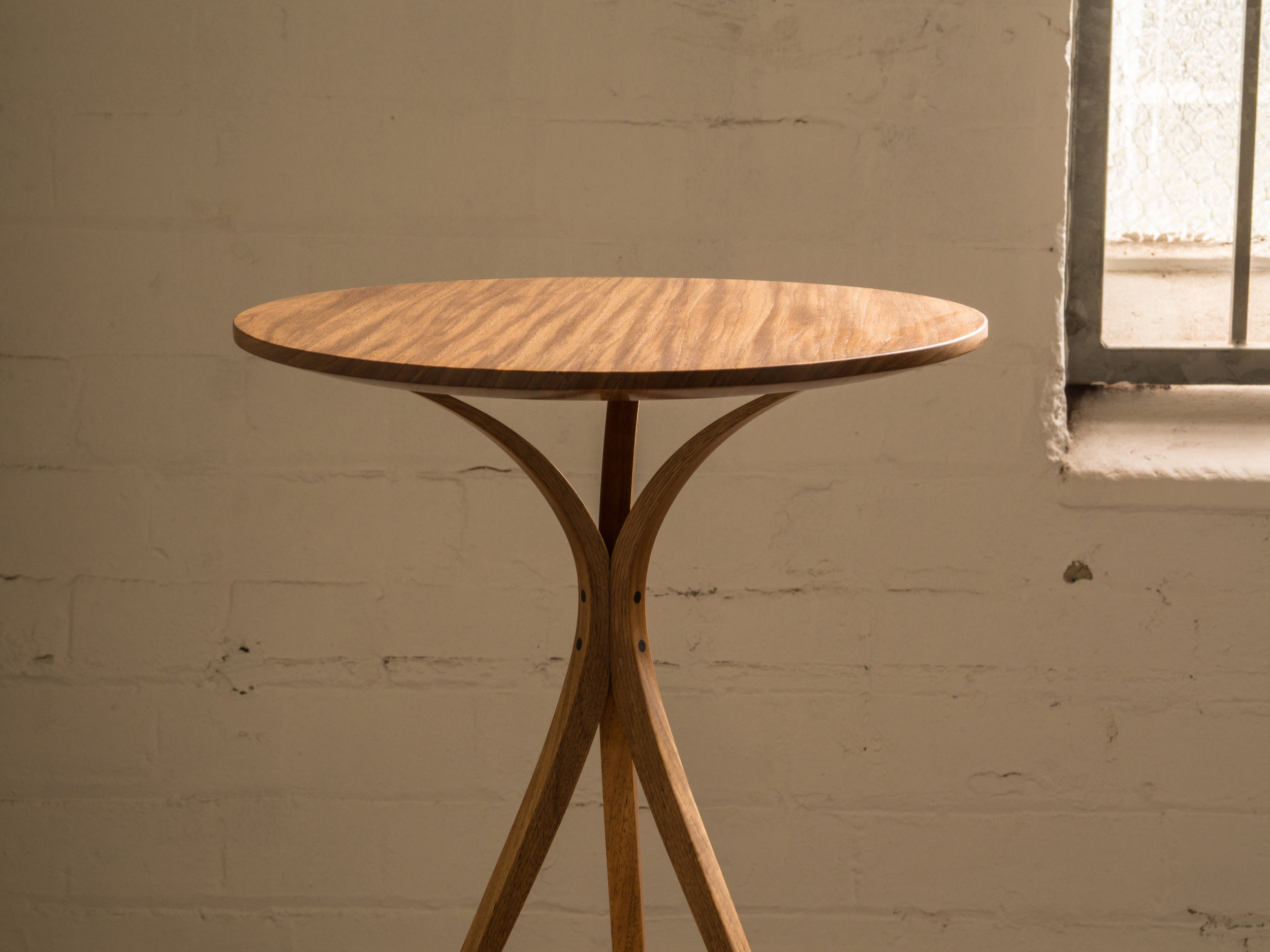 Keith's occassional table with twin tapered laminated legs.
