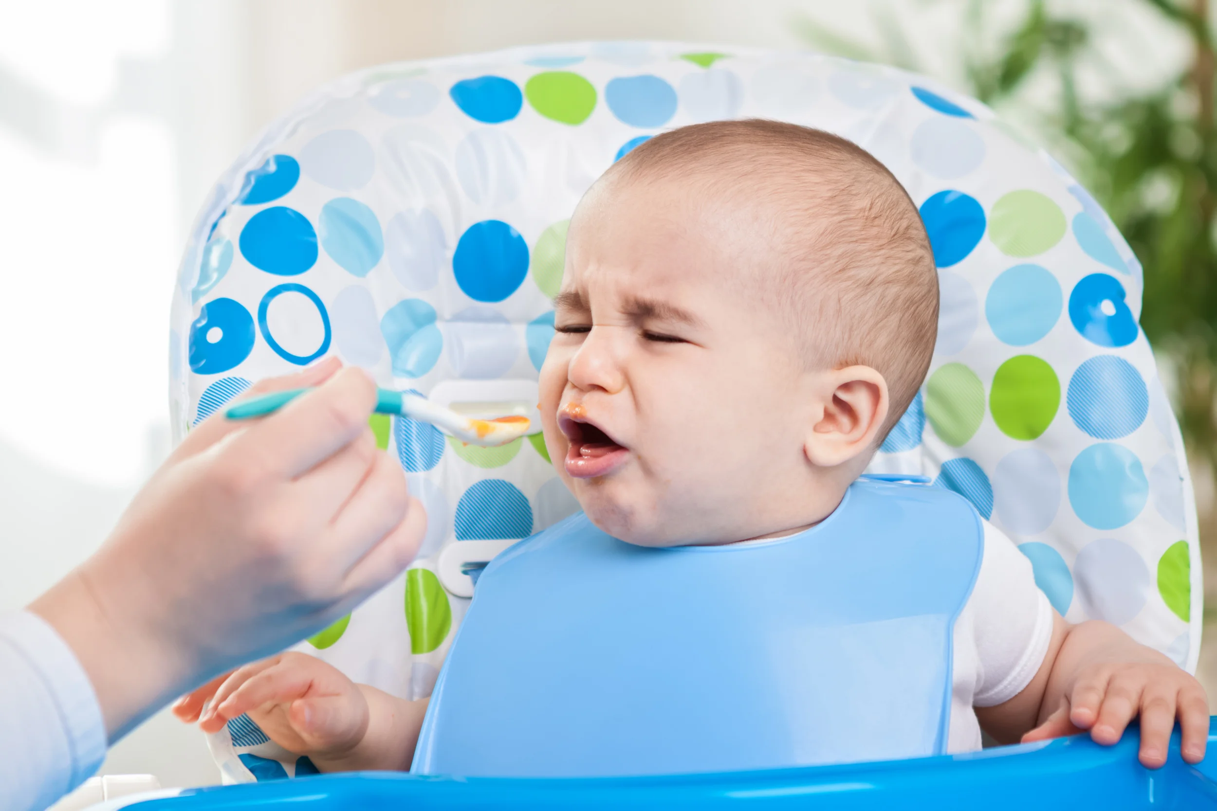 Angry baby doesn't like fruit mash